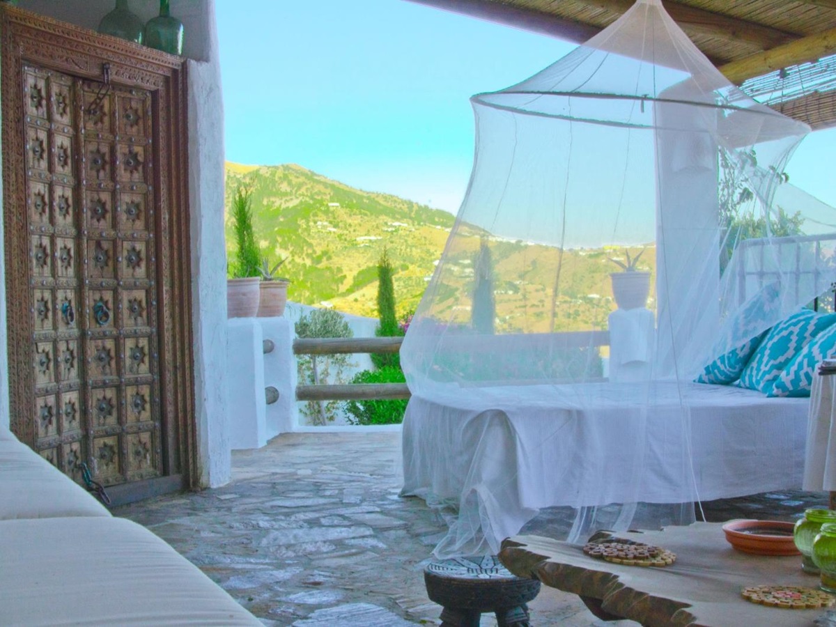 Shaded terrace with a bed-lounger overlooking the Andalucian mountains at El Refugio, luxury villa in Spain