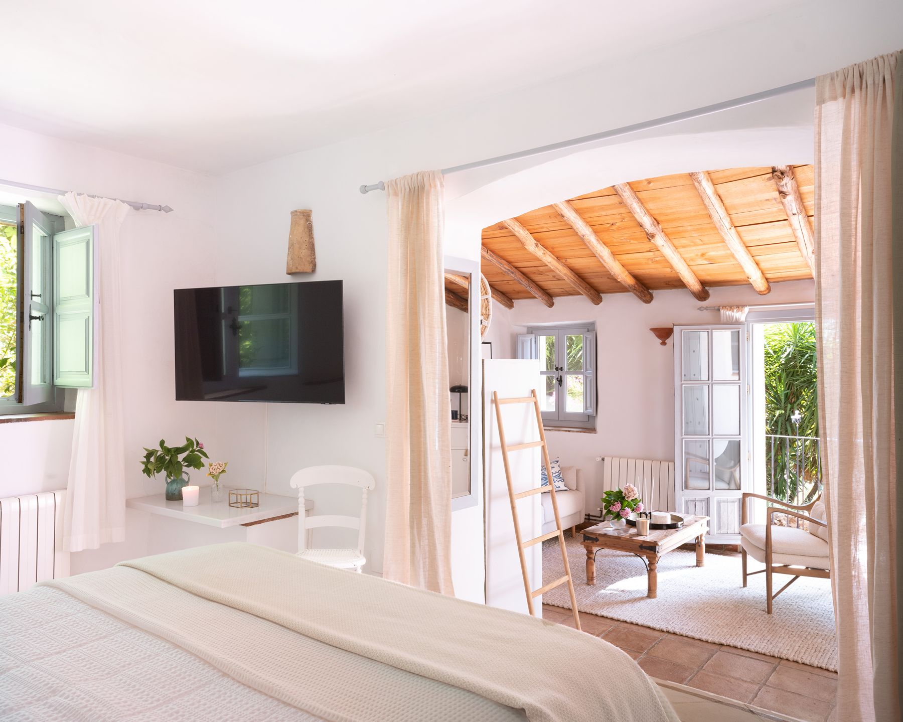 Double bedroom with seating area at Finca Flores, Andalucia