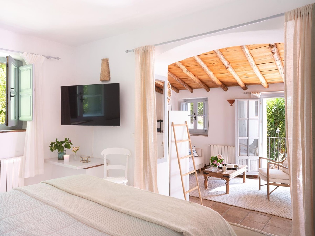 Double bedroom with seating area at Finca Flores, Andalucia