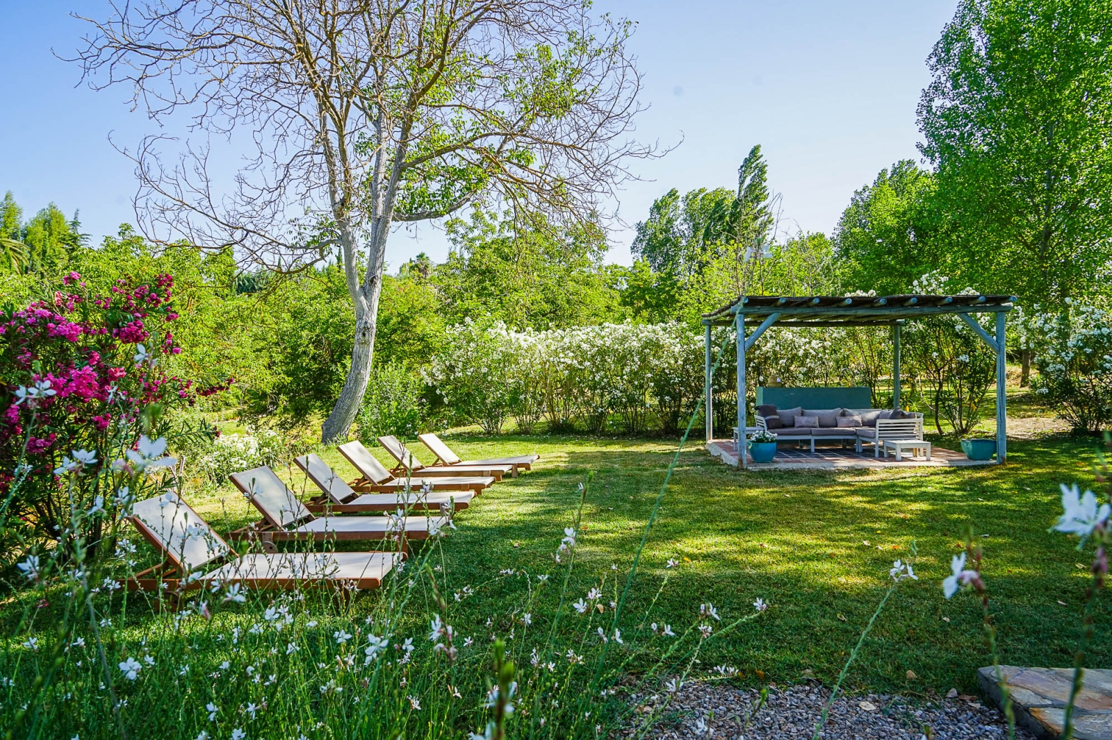 loungers and shaded seating in the gardens of Pero di Ronda, luxury villa in Spain
