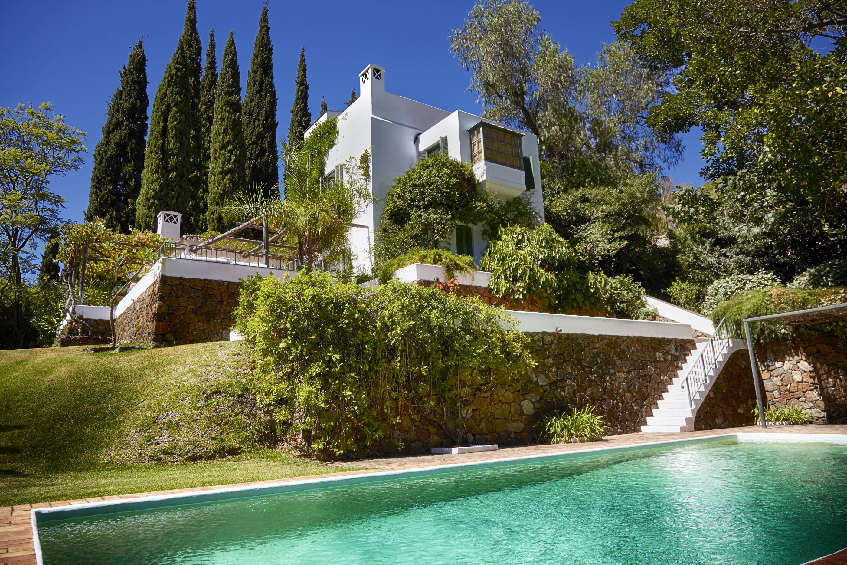 The facade and swimming pool of Tramores Estate, Andalucia