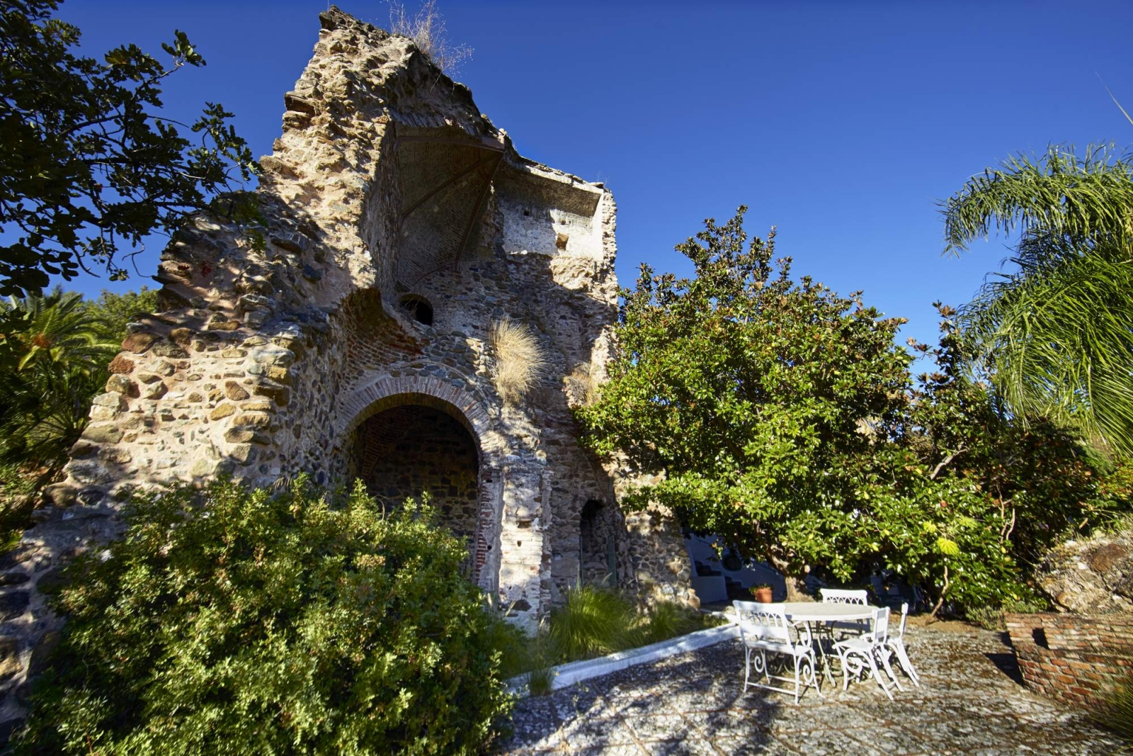 Patio and dining area by ancient ruins at Torre de Tramores in Andalucía, Spain