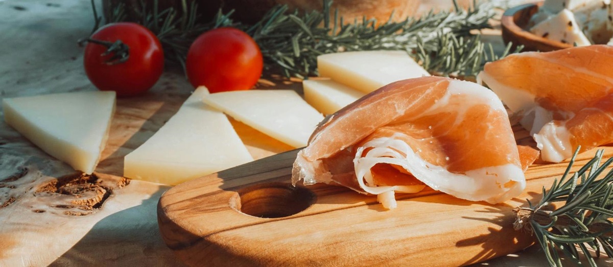 Serrano ham, cheese and tomatoes on a charcuterie board