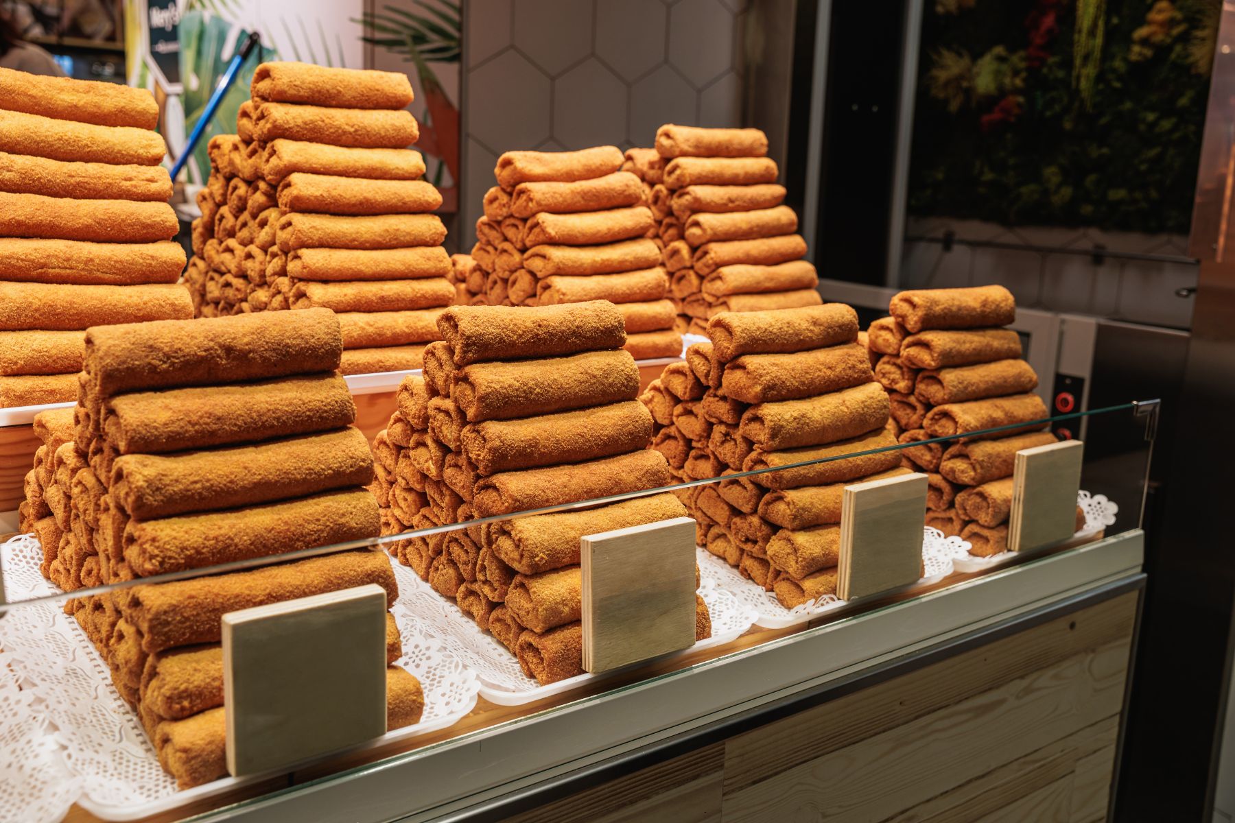 Stacks of flamenquins in a market in southern Spain