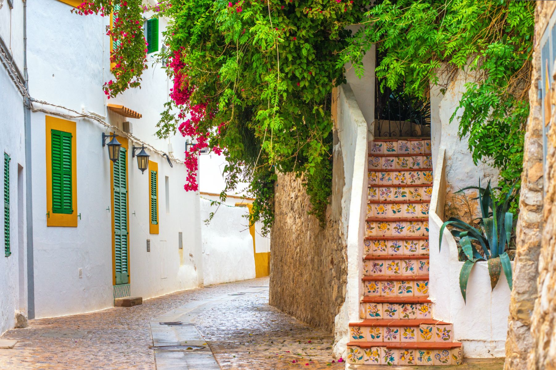 Ceramic tiled stairs and bougainvillea on a quiet street in Ibiza Old Town