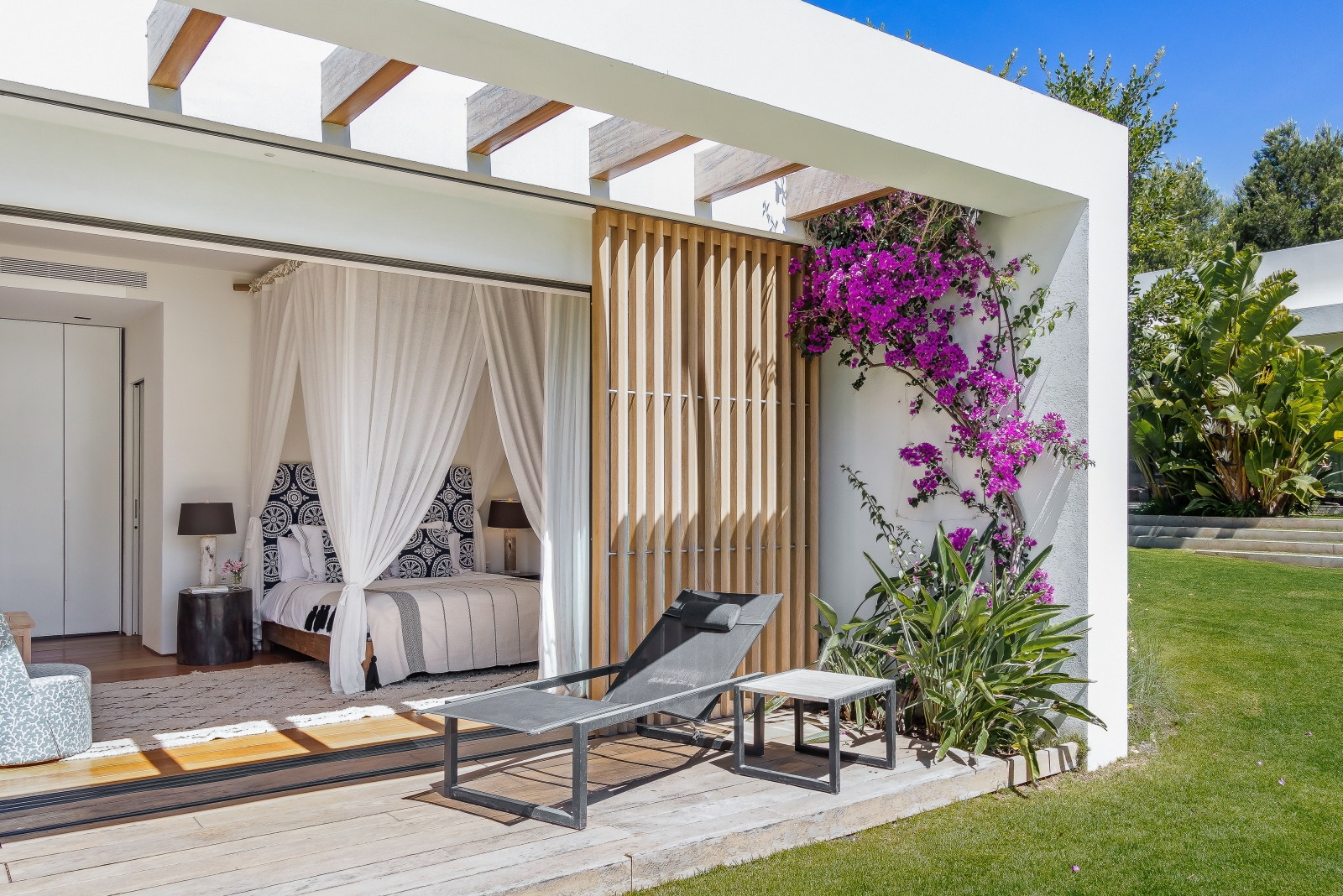 View into a bedroom with four poster bed at Villa Xi