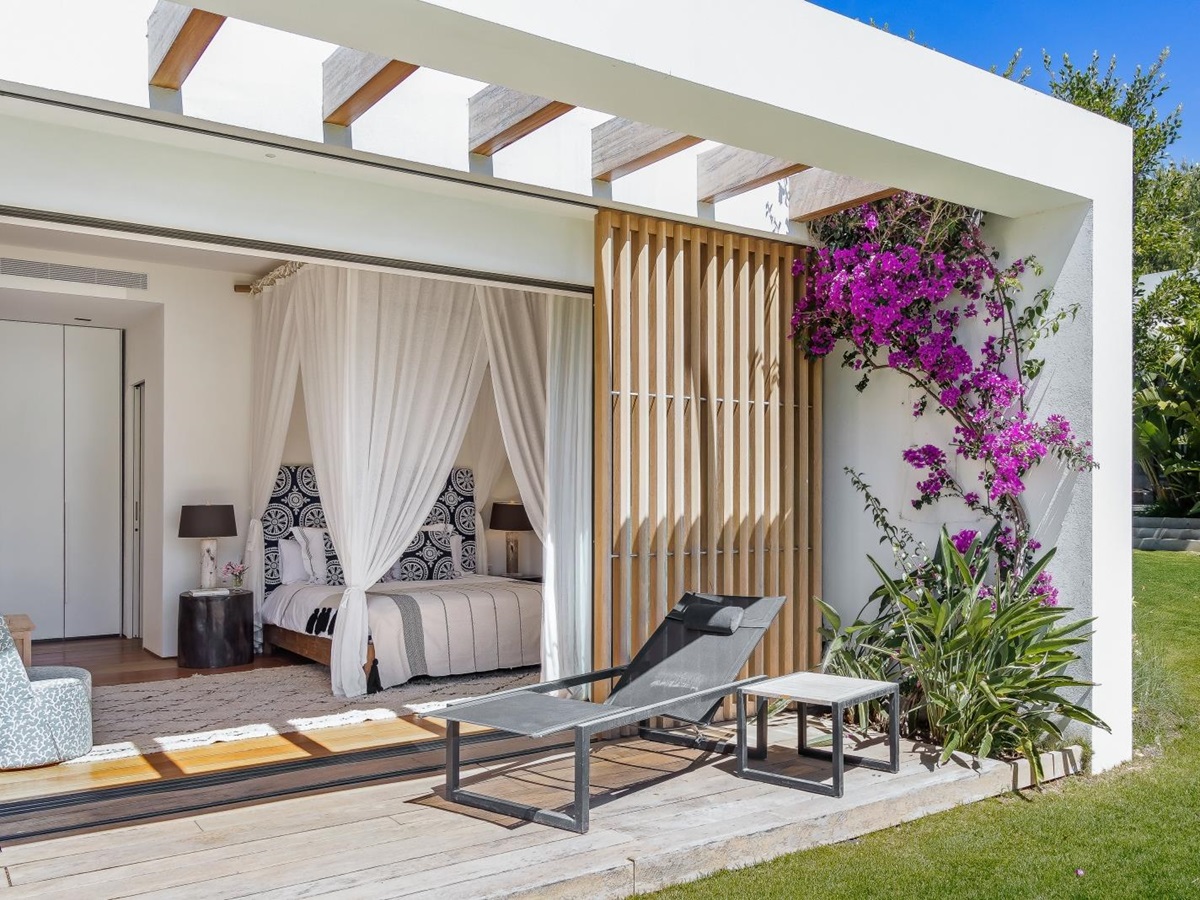 View into a bedroom with four poster bed at Villa Xi