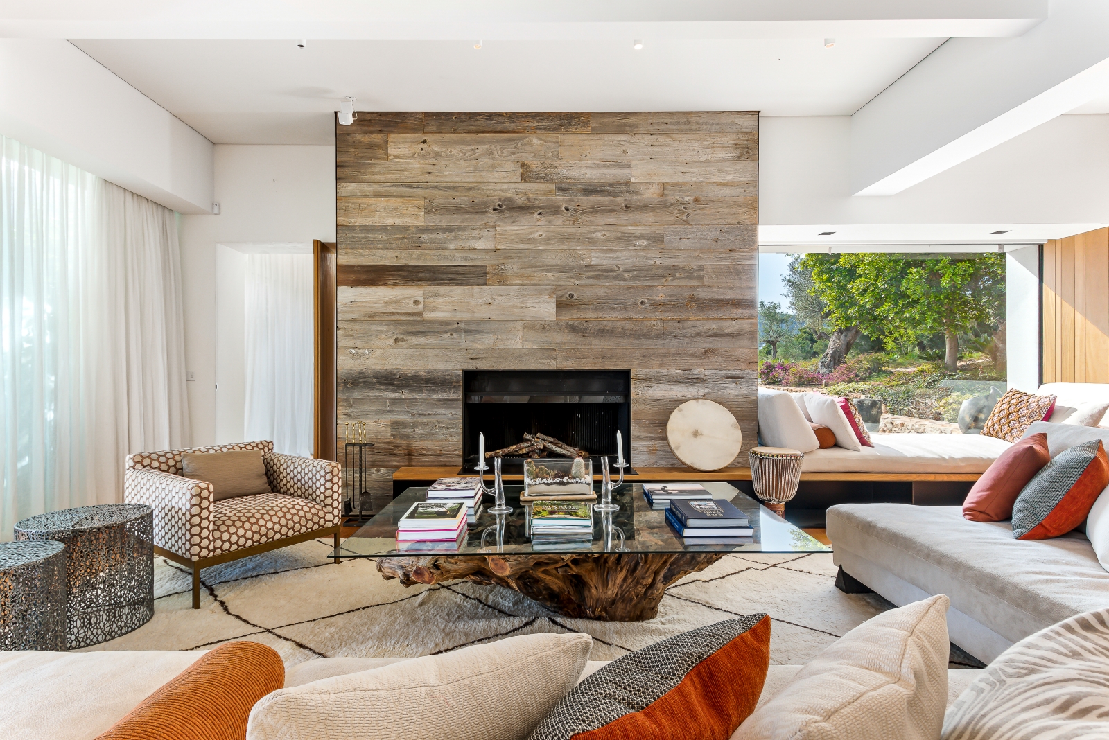 Indoor lounge of Villa Xi, equipped with fire place and feature wooden coffee table
