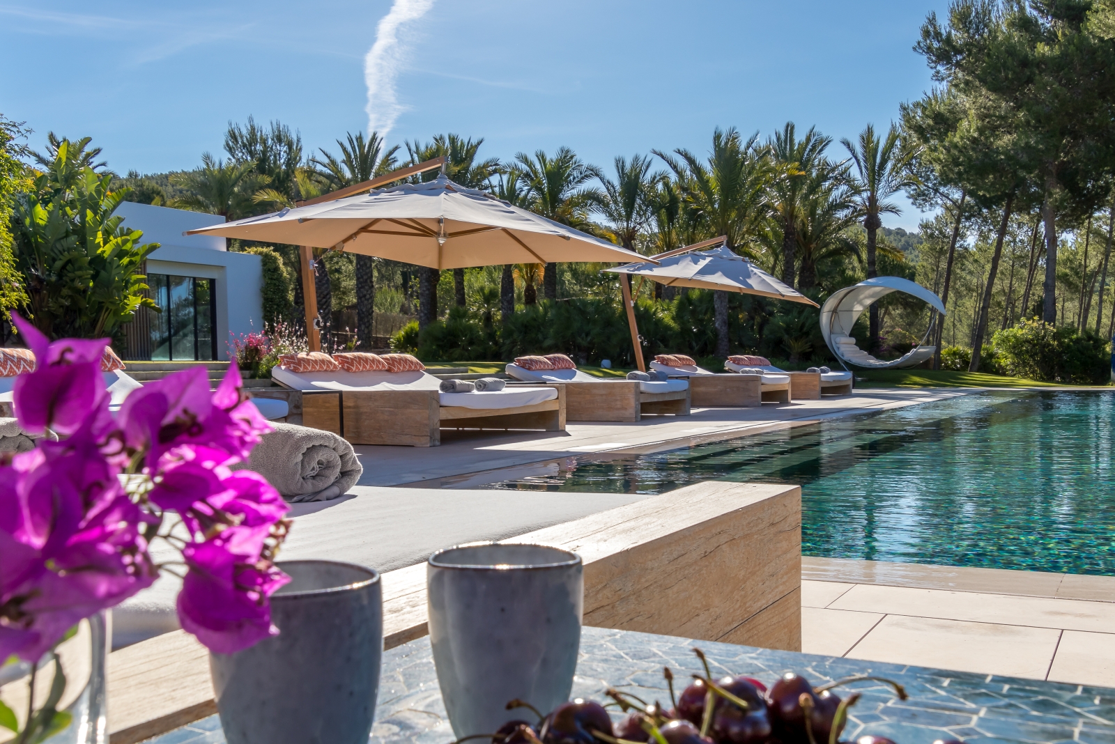 Four pool cabanas lined up by the pool of Villa Xi