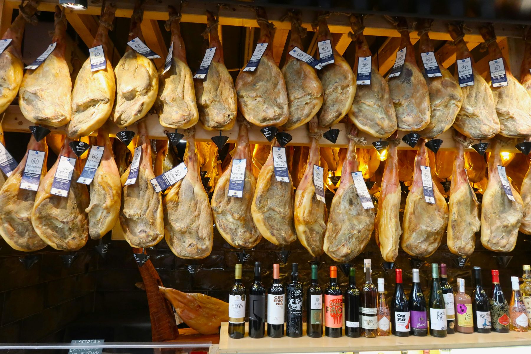 Legs of jamon iberico and wine at a bar in Spain