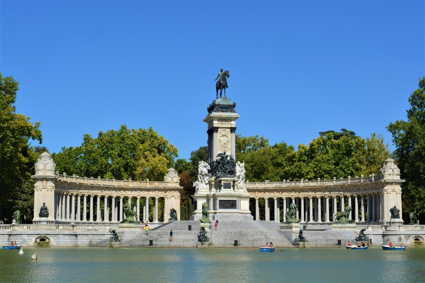 Park monument with lake and rowing boats in Madrid Spain