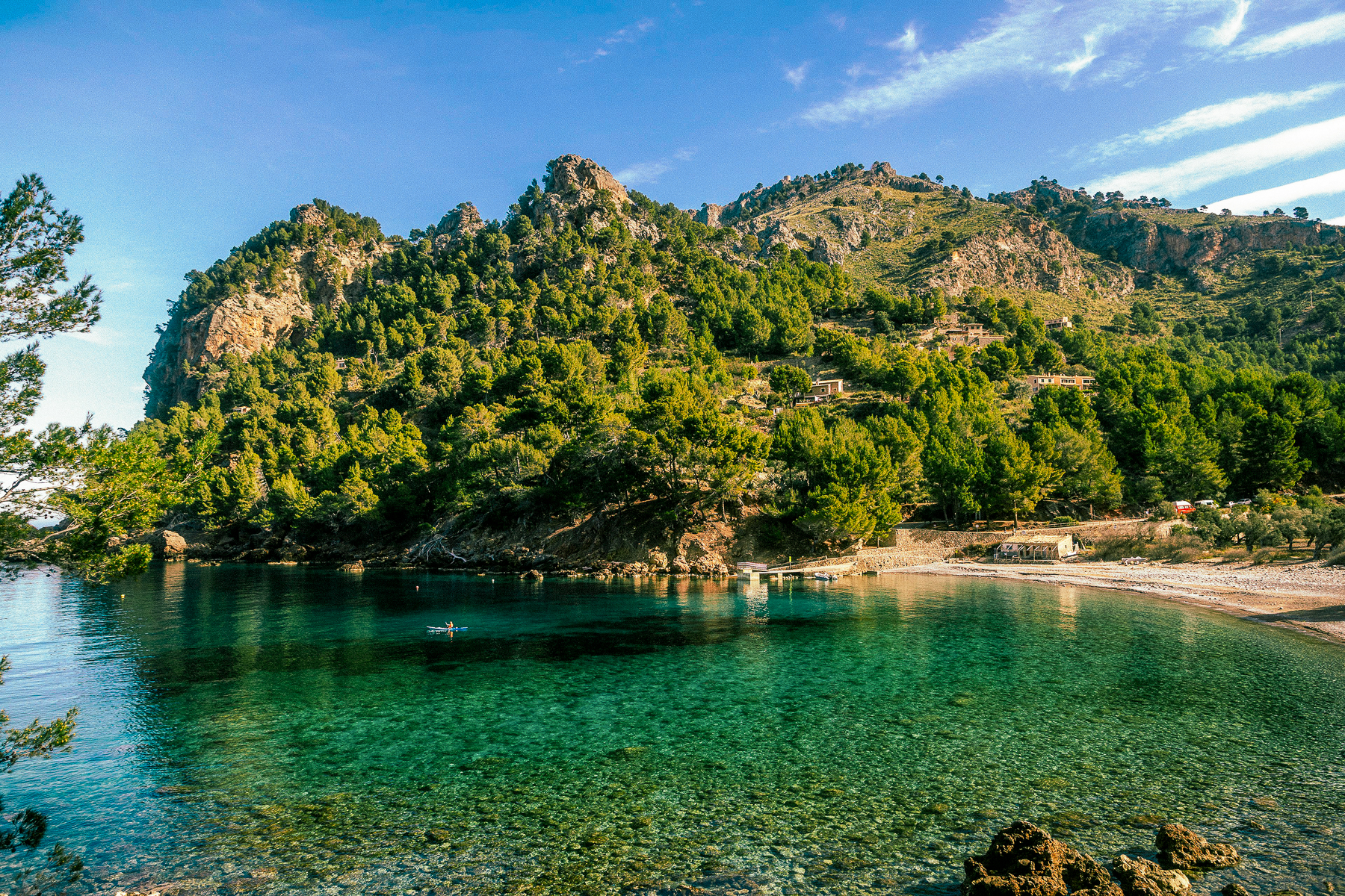 A man kayaking at Cala Tuent beach on Mallorca's north western coast