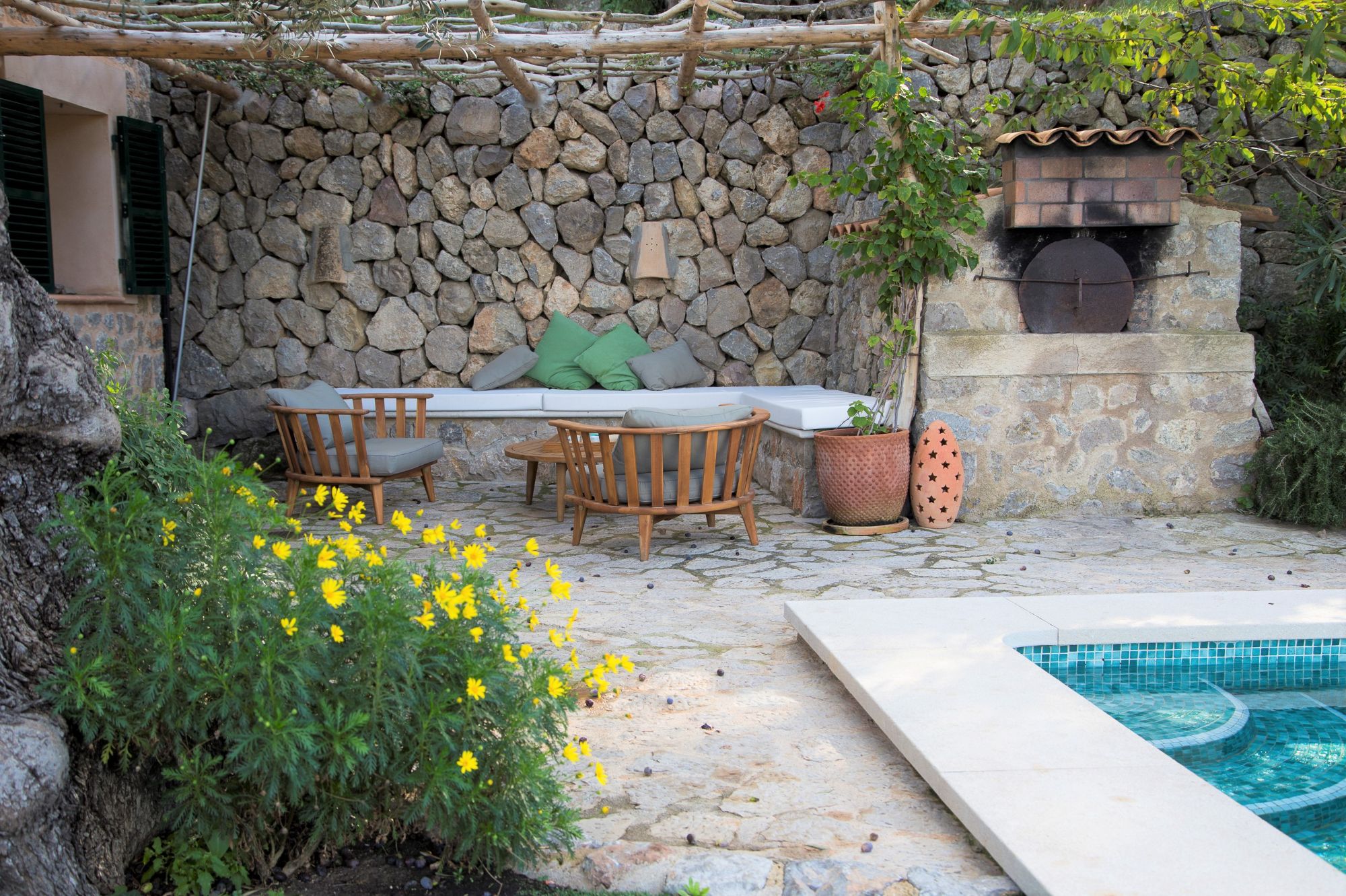 Poolside seating area at Can Olivia
