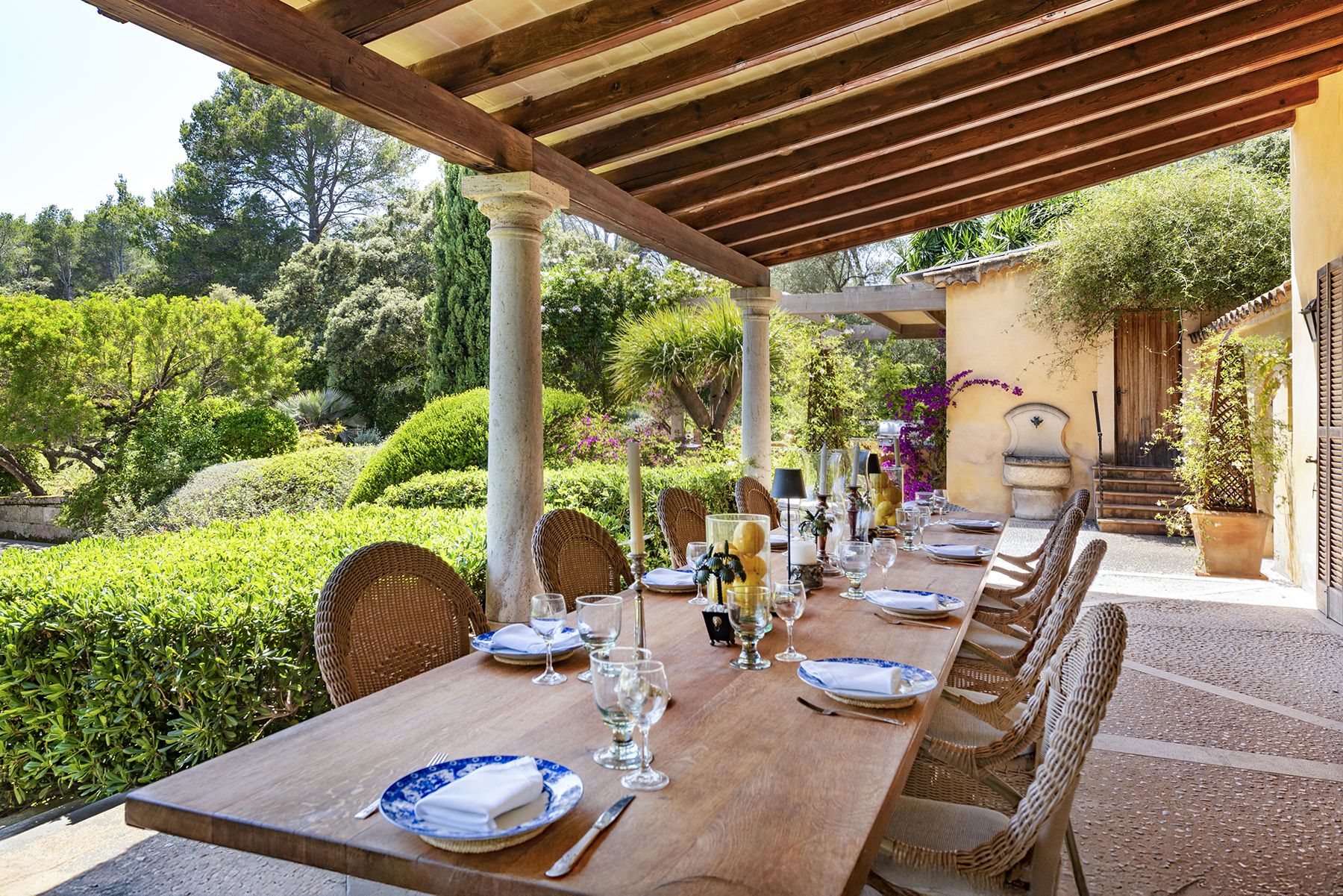 Covered terrace with dining table at Finca del Bosque, Mallorca