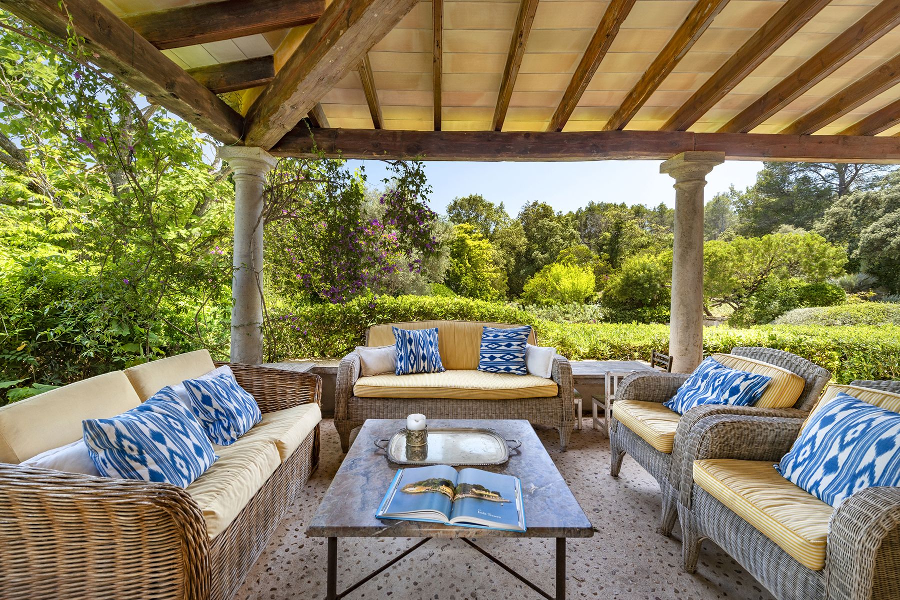 Covered seating area with views of garden at Finca del Bosque, Mallorca
