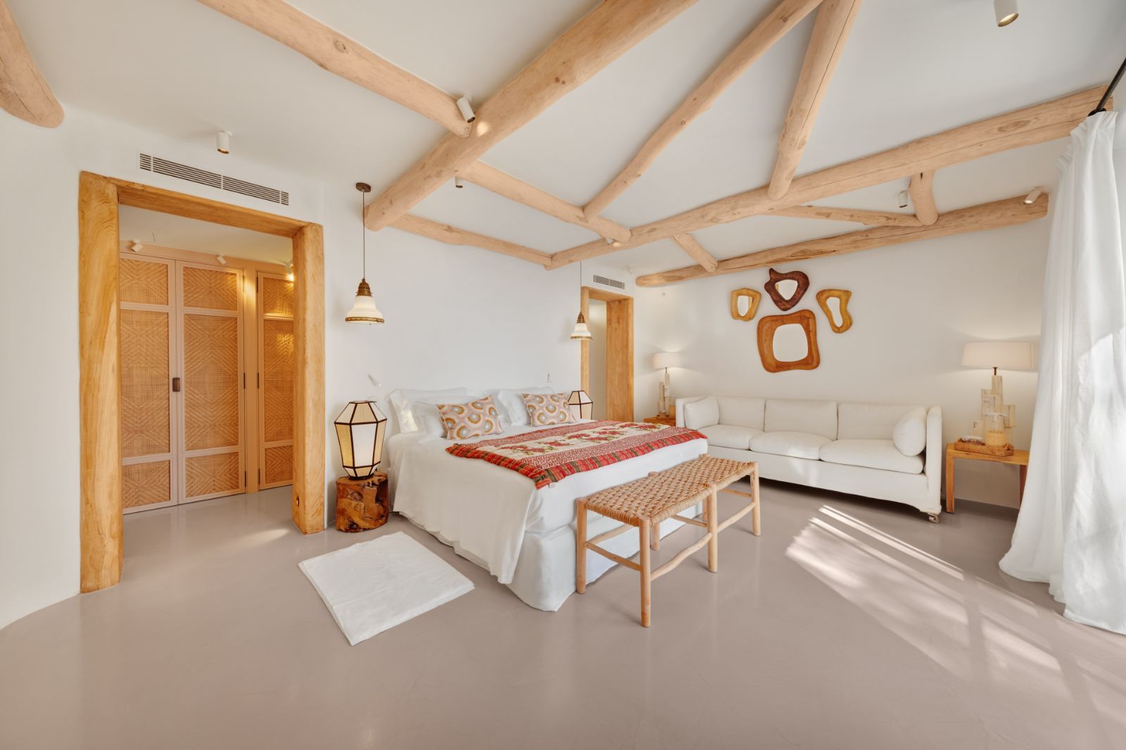 Double bedroom with sofa at Sa Fot, a luxury villa in northeast Mallorca