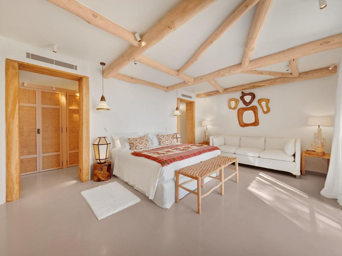 Double bedroom with sofa at Sa Fot, a luxury villa in northeast Mallorca