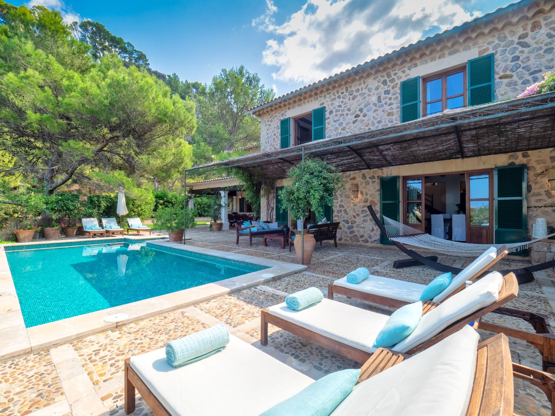 Pool with loungers at Villa Caleta, Mallorca