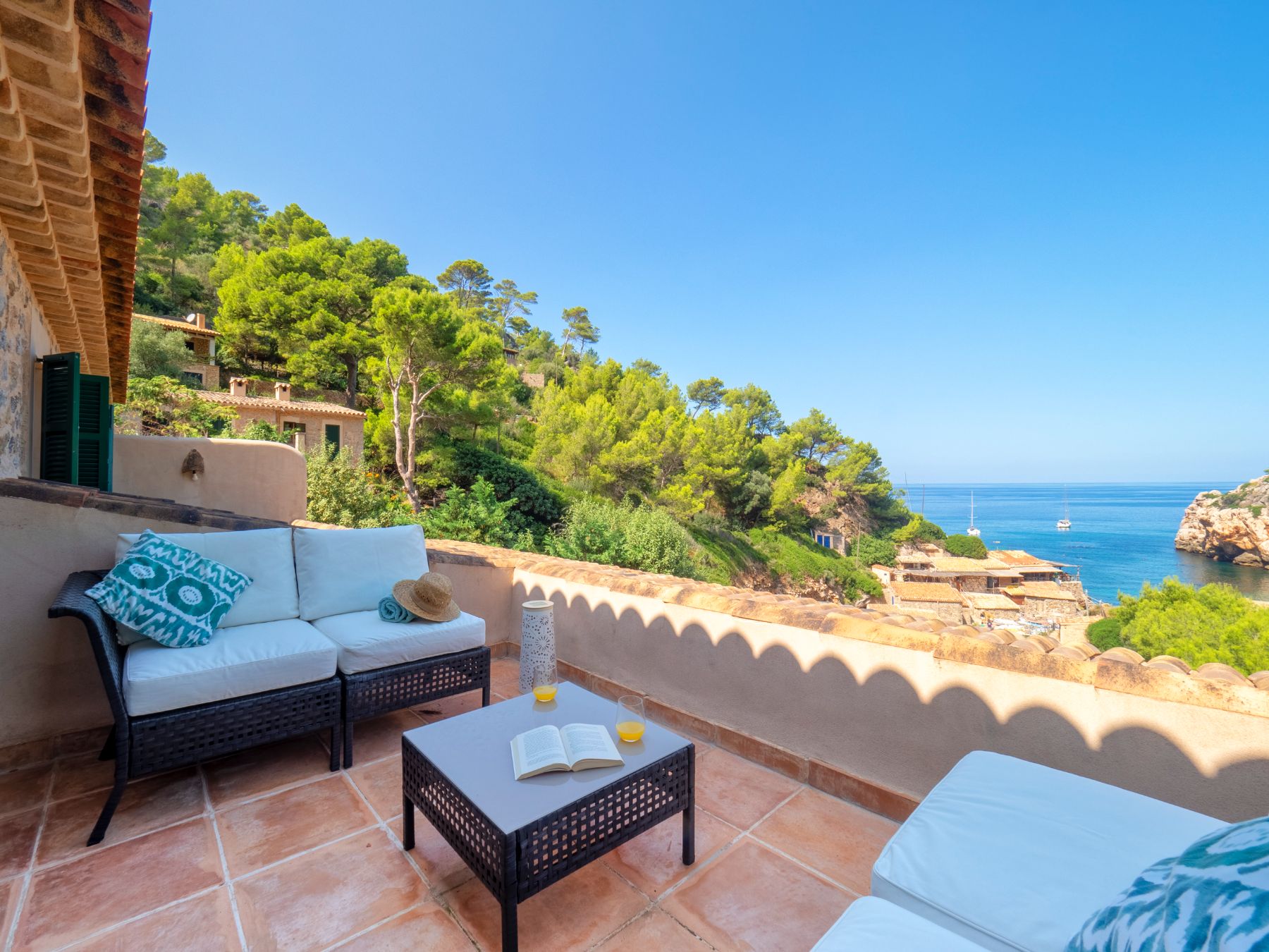 Terrace with seating and sea views at Villa Caleta, Mallorca