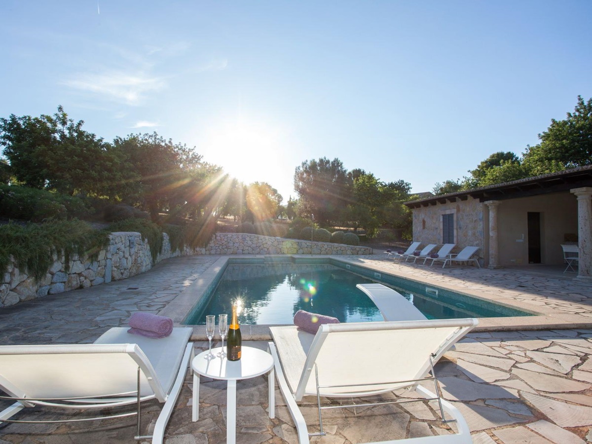 Pool with sun loungers at Villa Maria, Mallorca
