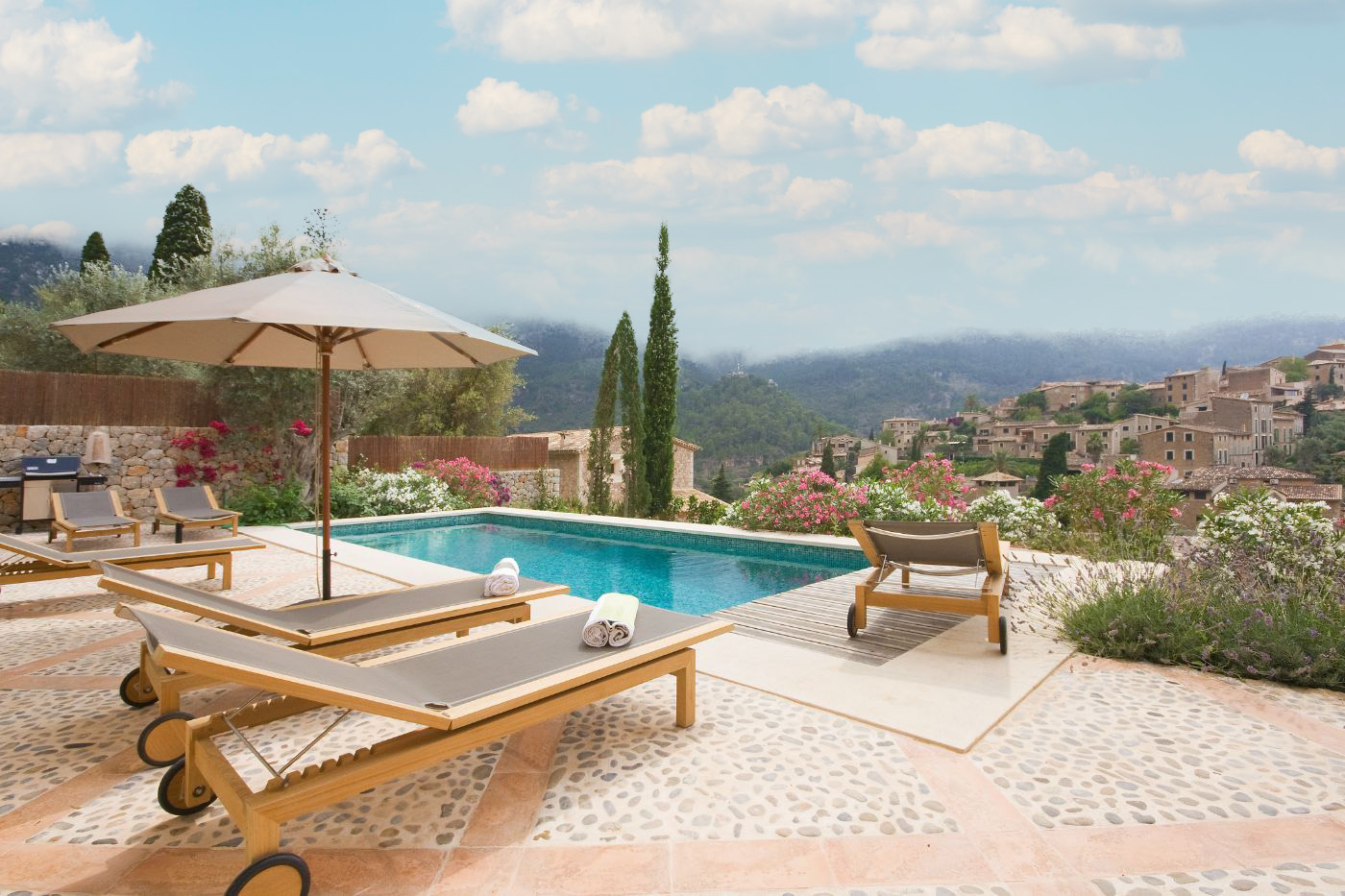 Pool with sun loungers at Villa Serena