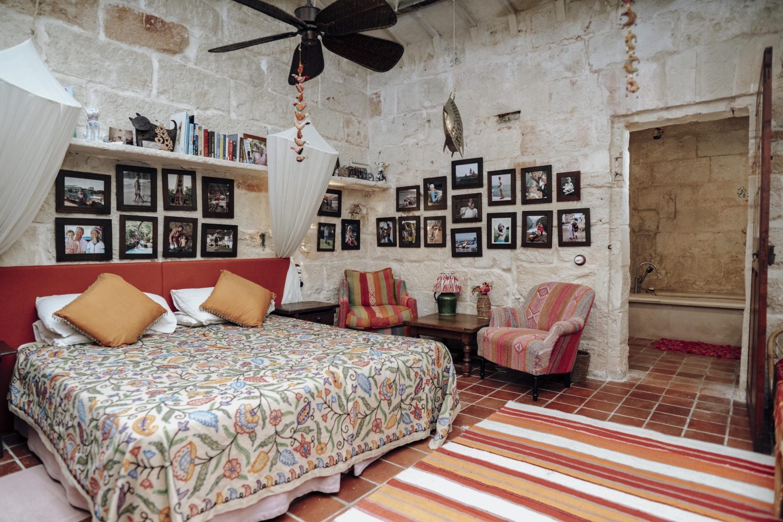 Expansive double bedroom with ensuite bathoom, fan and mosquito nets at Binicalaf, luxury villa in Menorca