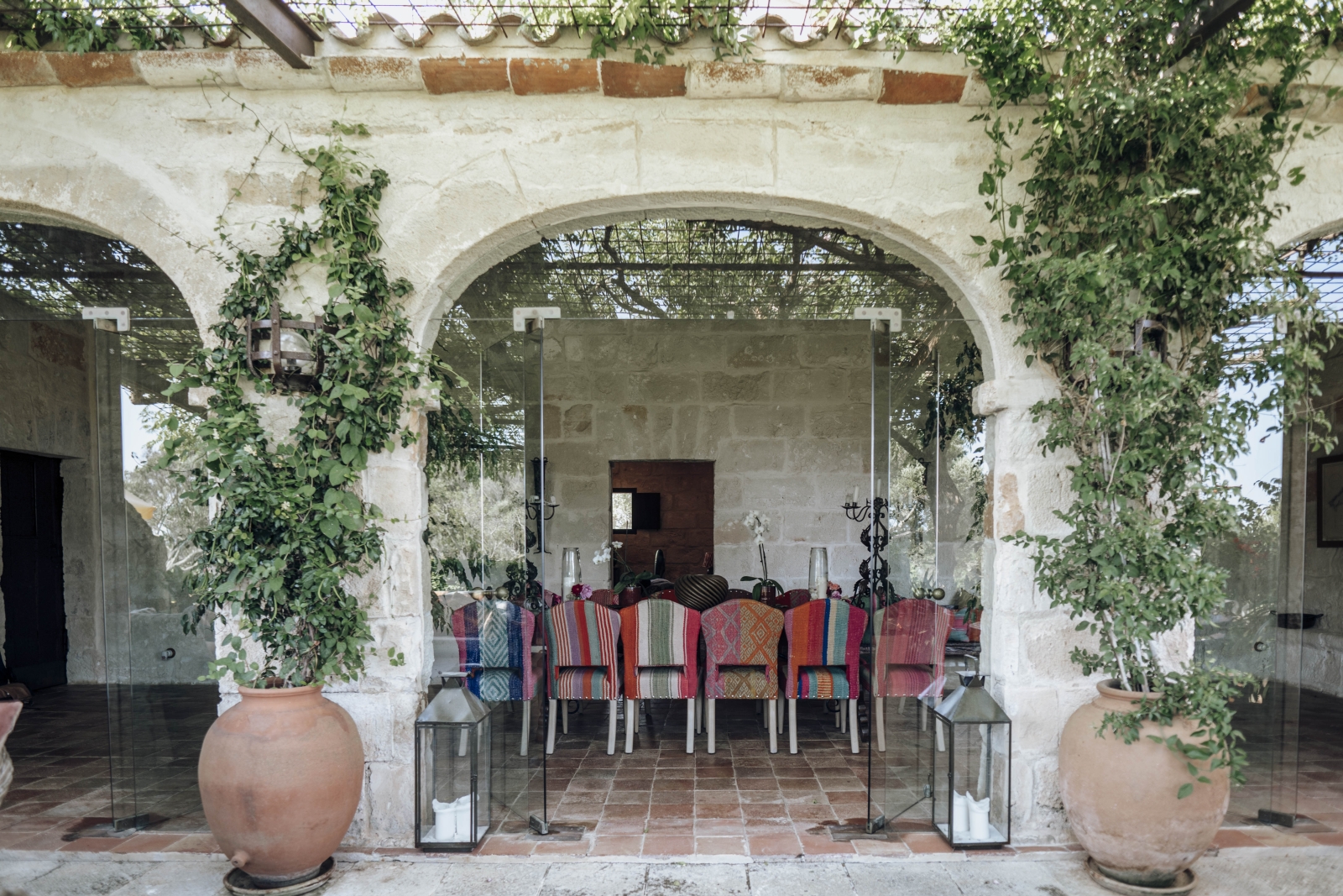 view into the indoor dining room through glass doors at Binicalaf, luxury villa on Menorca