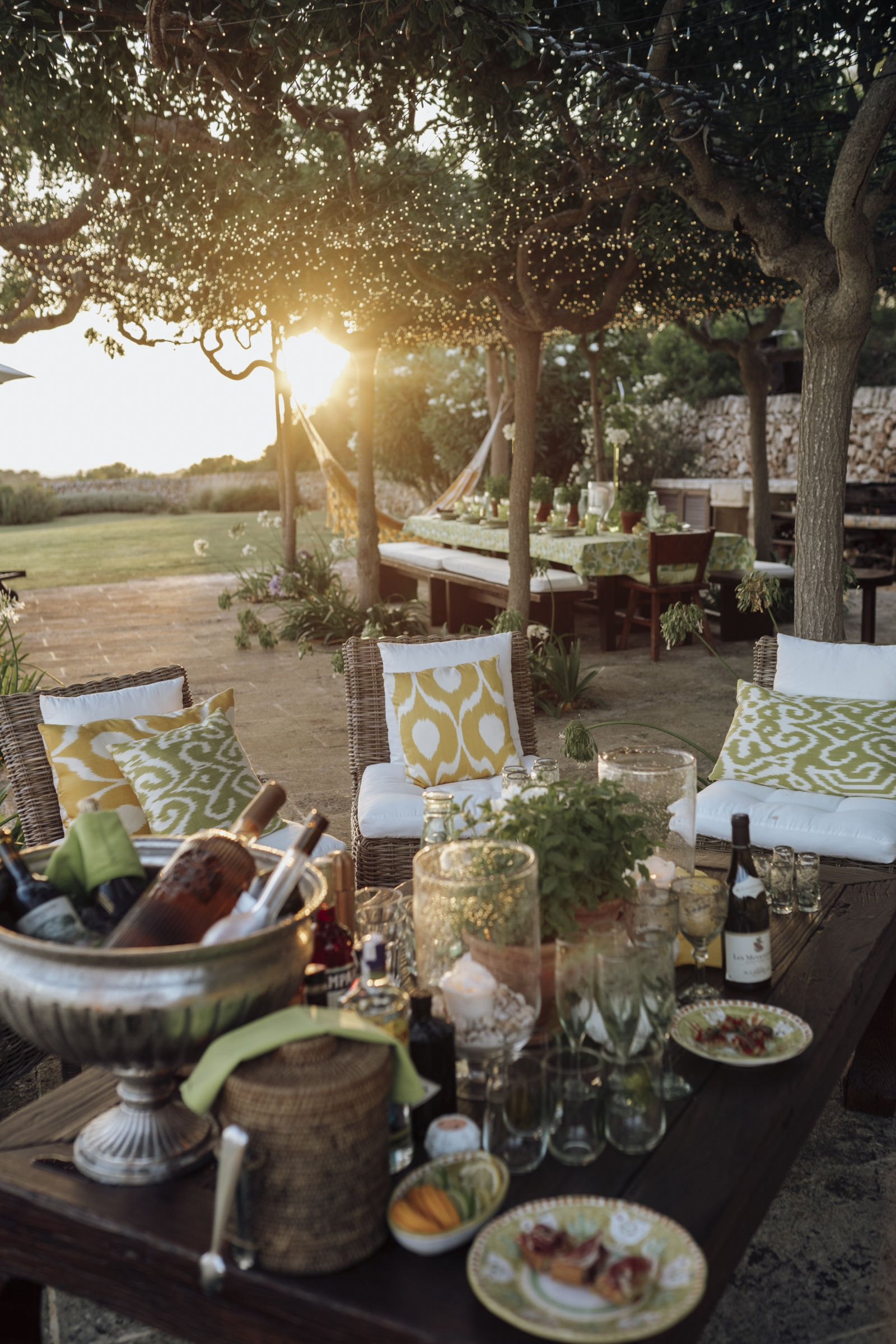 Small seating area with drinks and snacks at Binicalaf at sunset