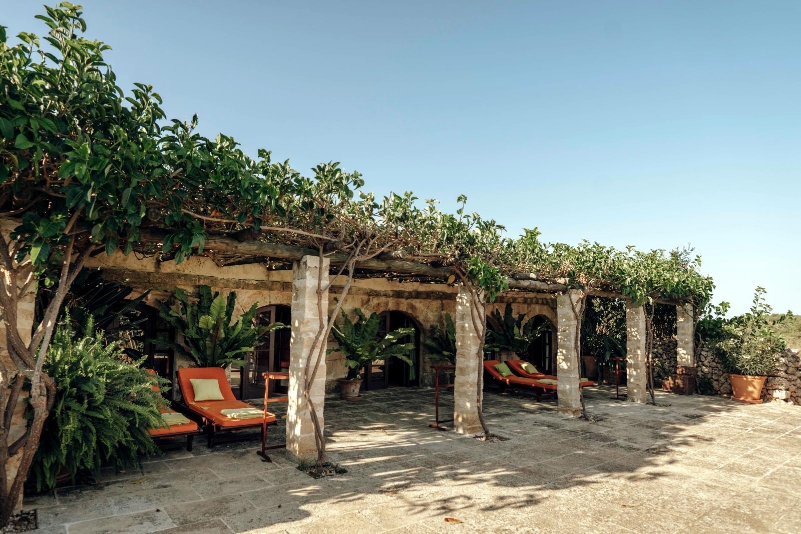 Shaded loungers along the main building of luxury villa binicalaf on Menorca