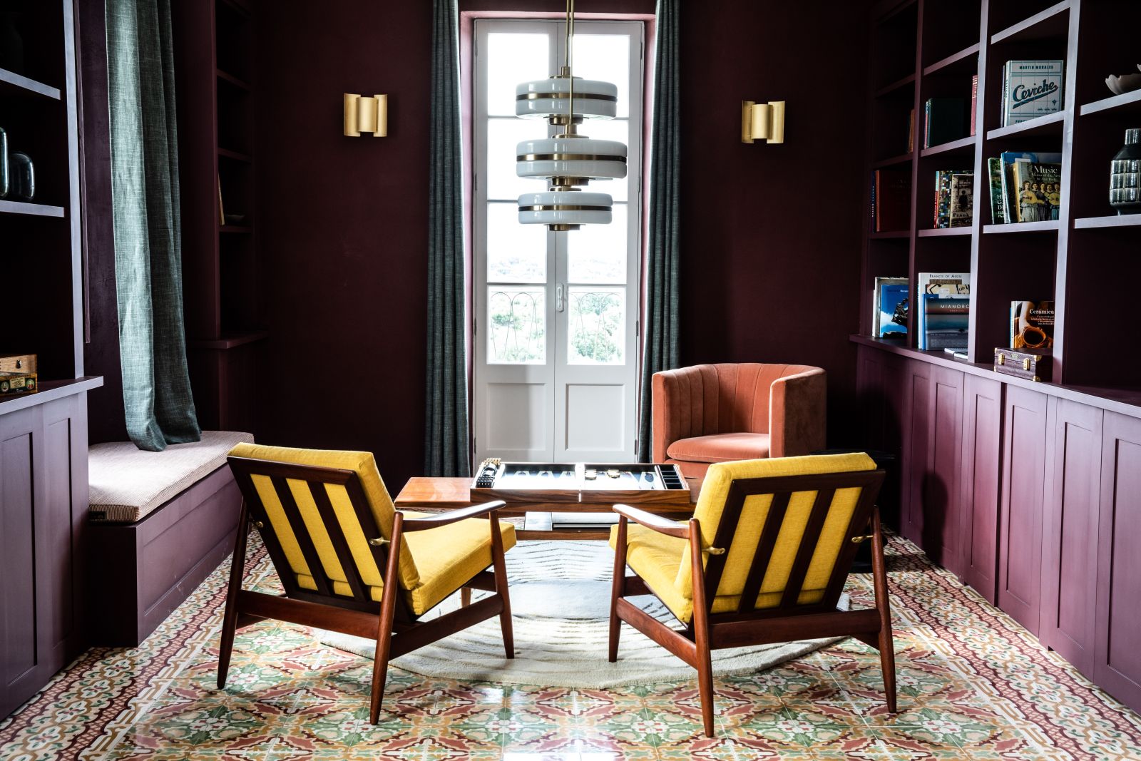 two chairs with yellow  cushions in front of a table with back gammon set at luxury villa Casa Benedicta in Menorca 