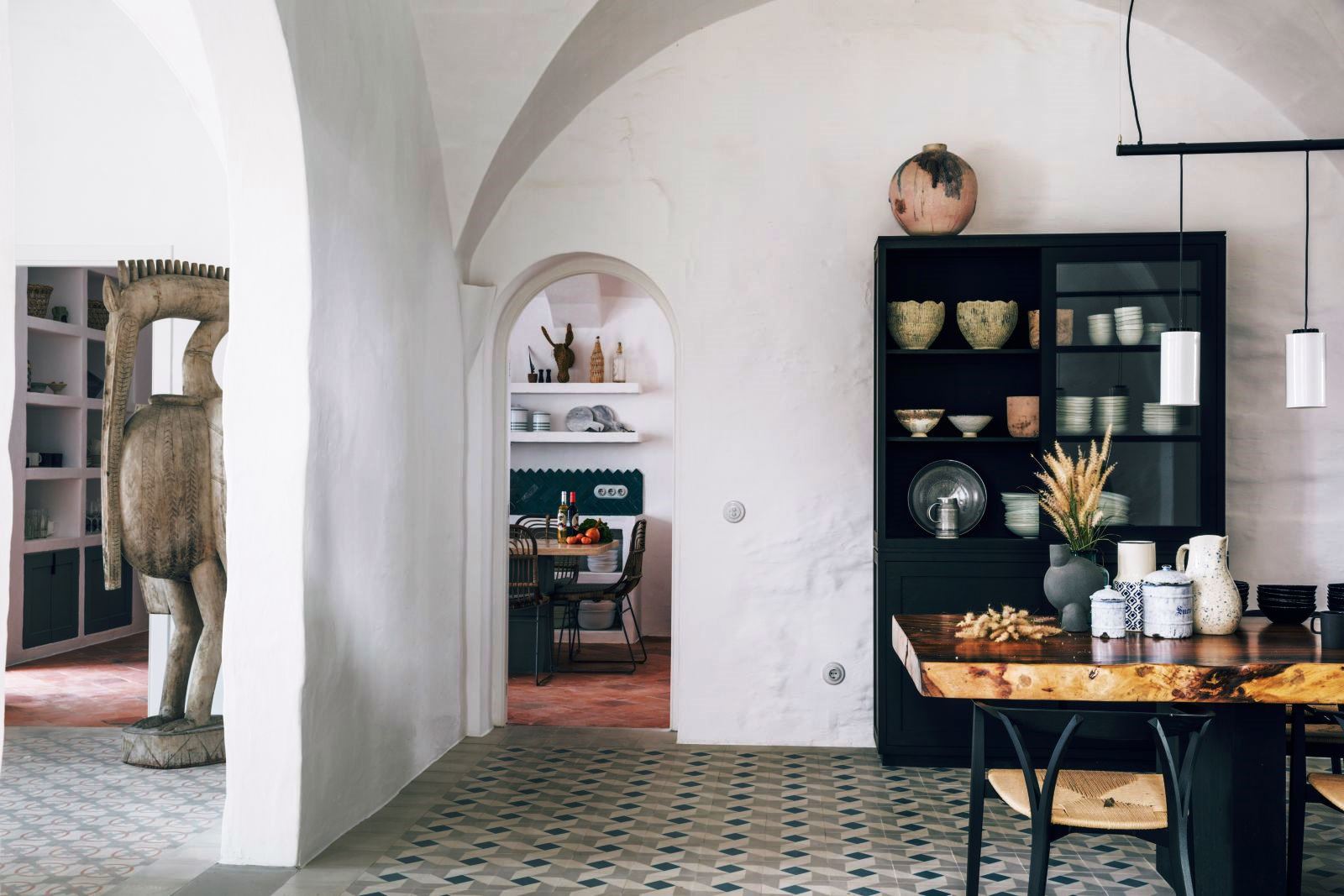 dining area leading through archway to kitchen at luxury villa Casa Benedicta in Menorca 