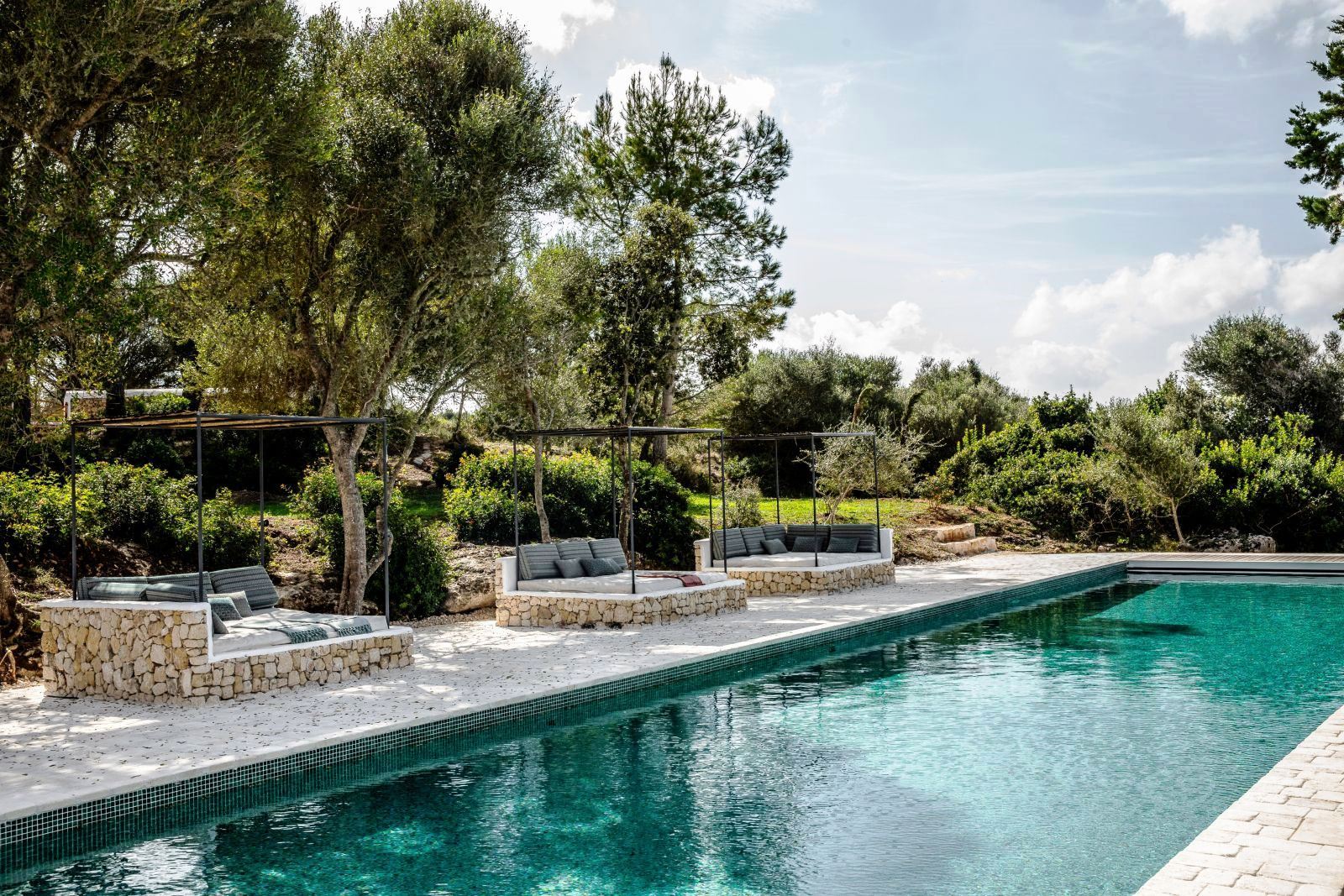swimming pool and three day beds under canopys at luxury villa Casa Benedicta in Menorca 
