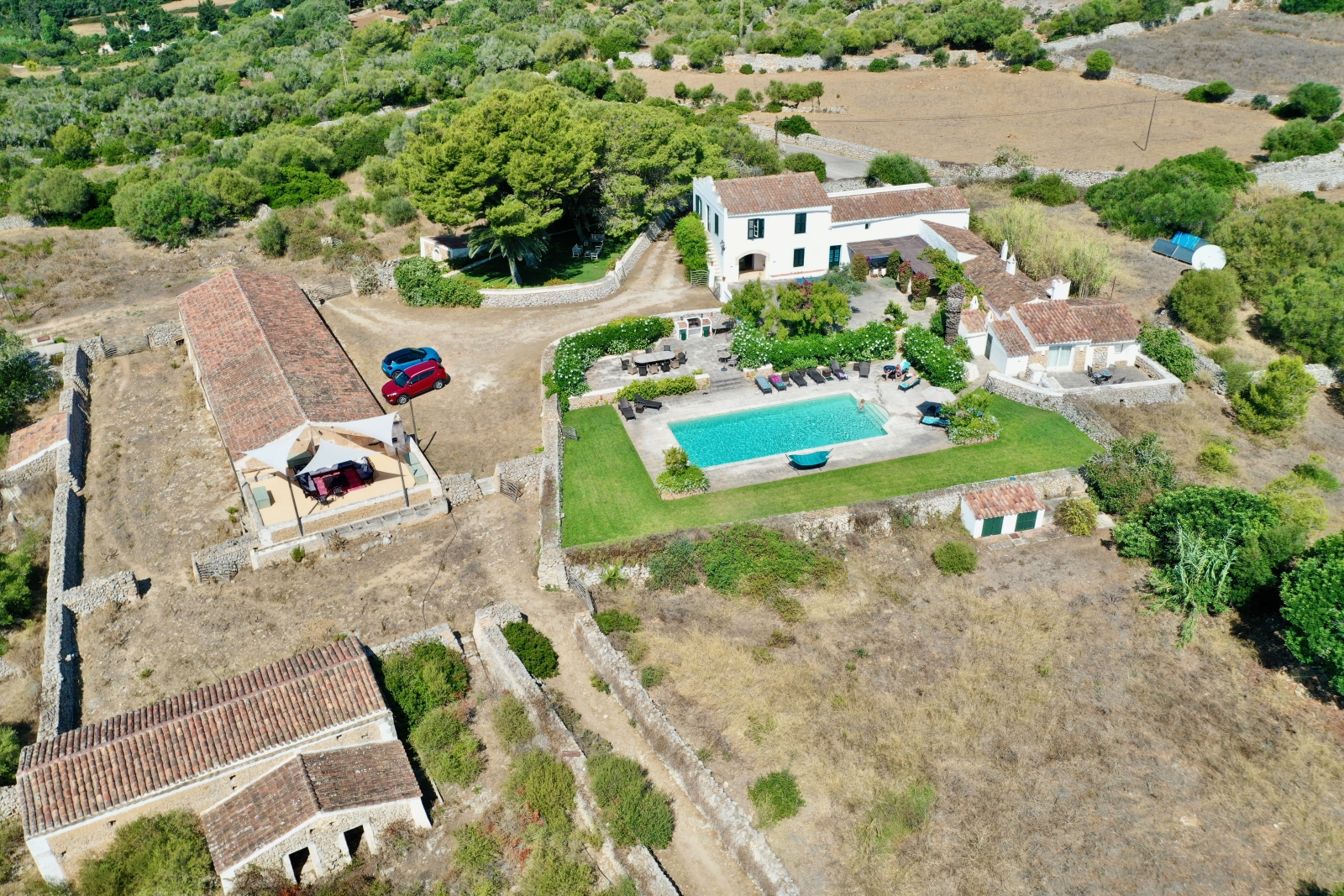 Aerial view of villa, pool and outdoor dining area at Finca Tortuga in Menorca, Spain