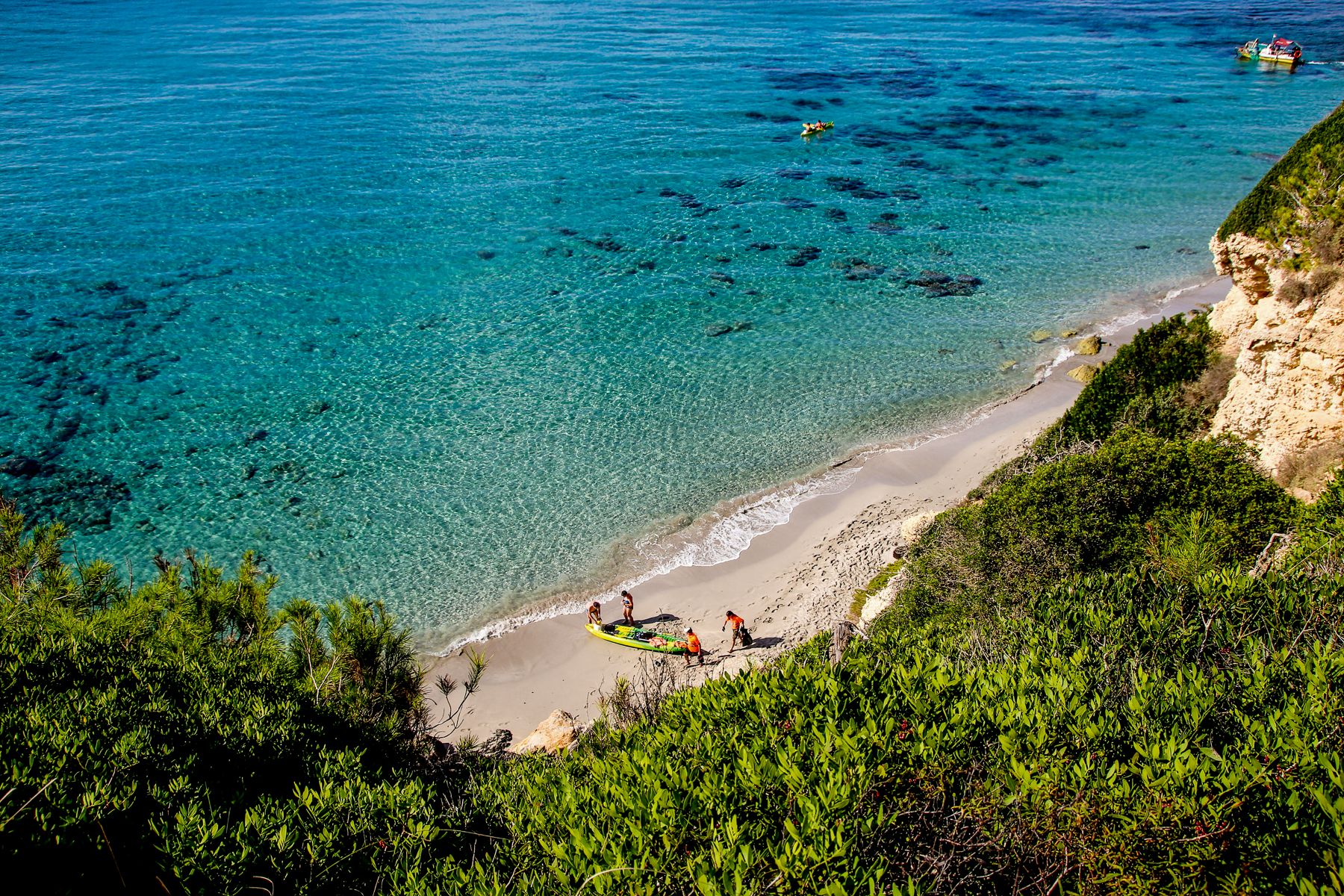 Guests with a boat on a beach in Menorca