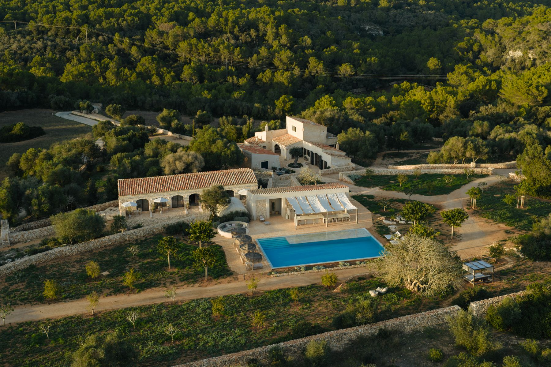 View of house, pool and gardens at Villa Solana, Menorca