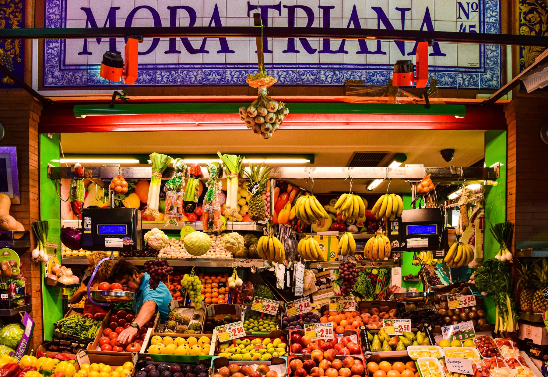 Fruit vendor at a stall in the Mercado de Triana Seville