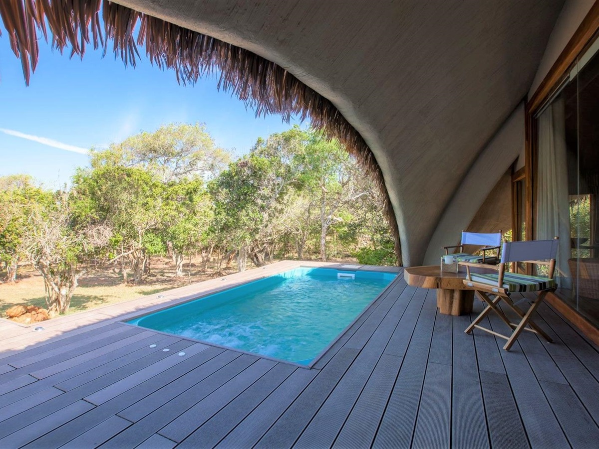 Guest deck and plunge pool at Chena Huts in Yala National Park in Sri Lanka