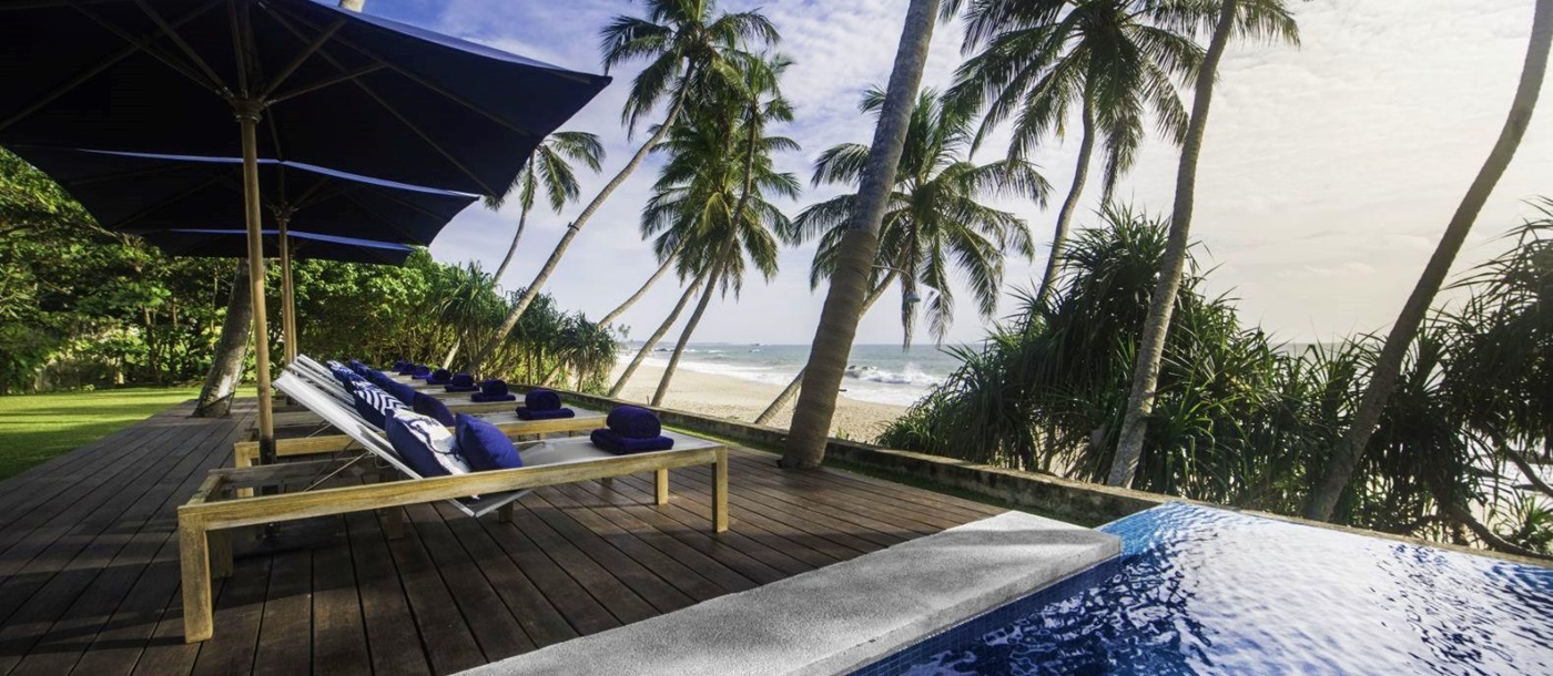 Poolside sunbeds at Kumu Beach on the south coast of Sri Lanka