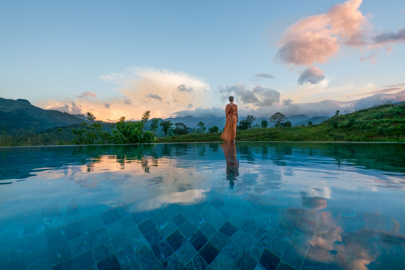 Lady admiring the views from the infinity pool at Santani Wellness Resort in Sri Lanka