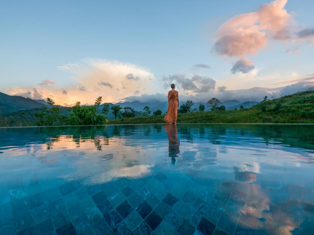 Lady admiring the views from the infinity pool at Santani Wellness Resort in Sri Lanka