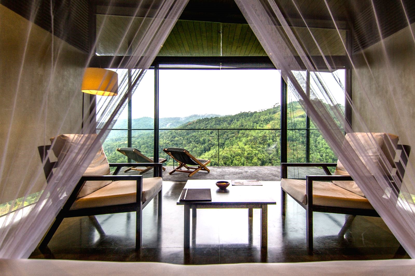 Interior and terrace of a Mountain View Chalet at Santani Wellness Resort in Sri Lanka