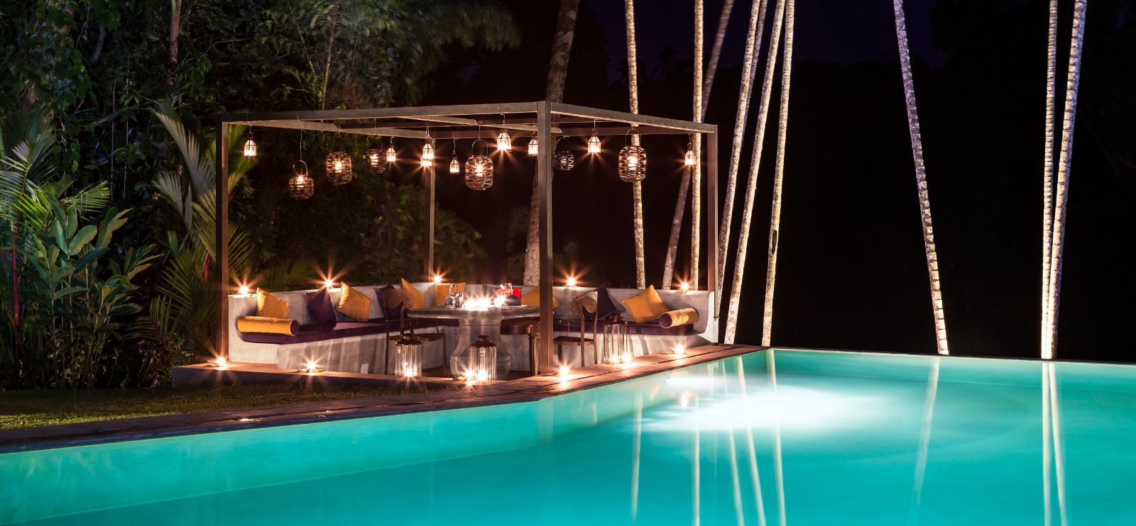 poolside seating area at night at The kandy house in Sri Lanka