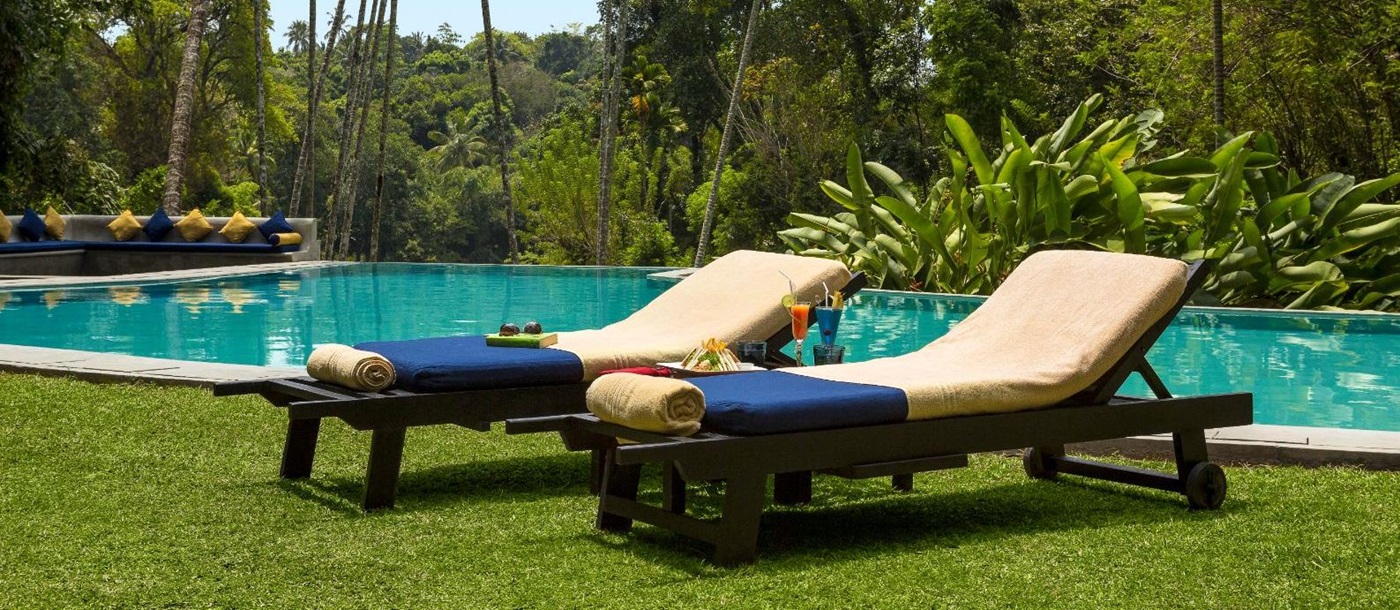 Poolside sunbeds at The kandy house in Sri Lanka