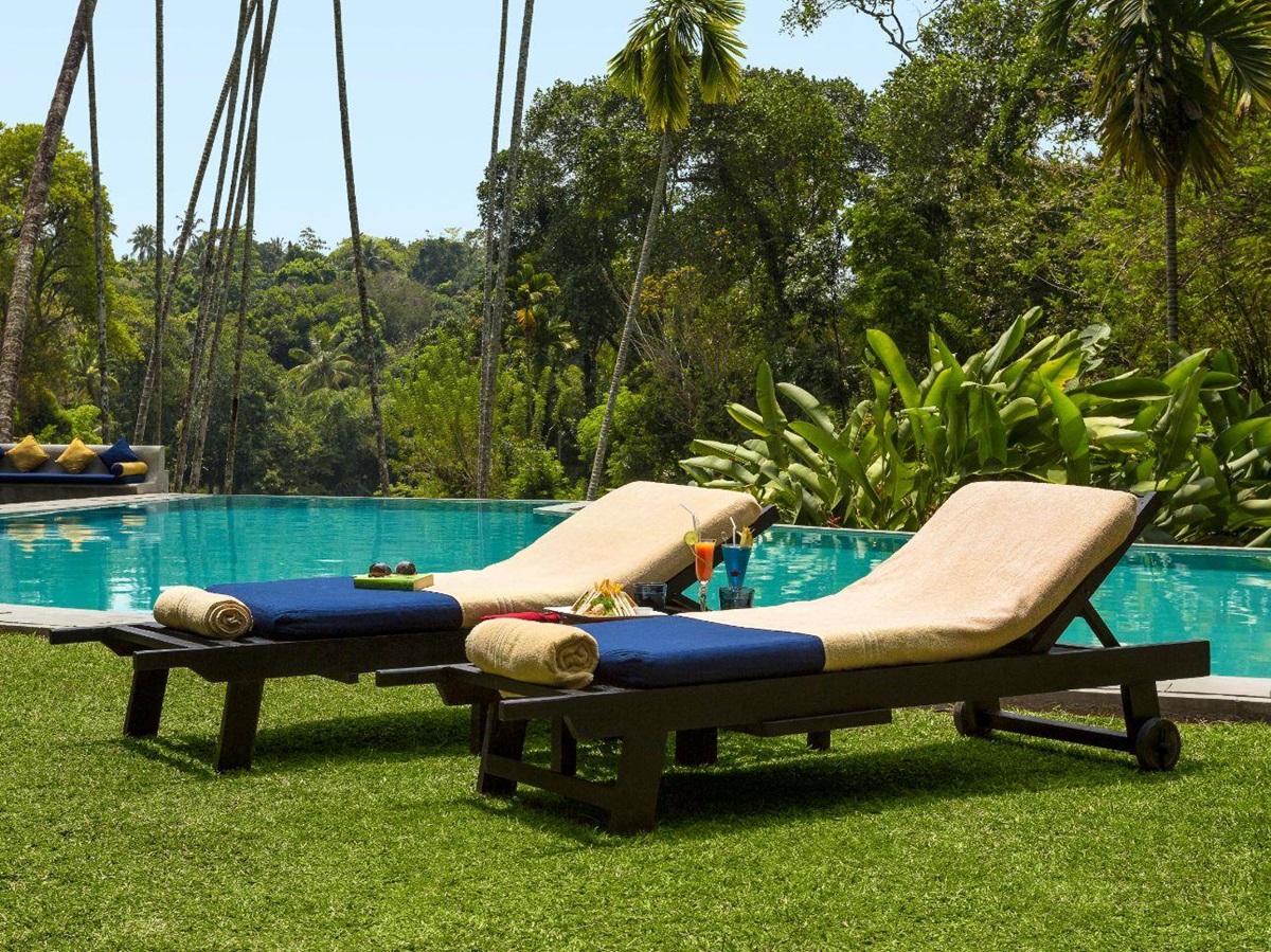 Poolside sunbeds at The kandy house in Sri Lanka