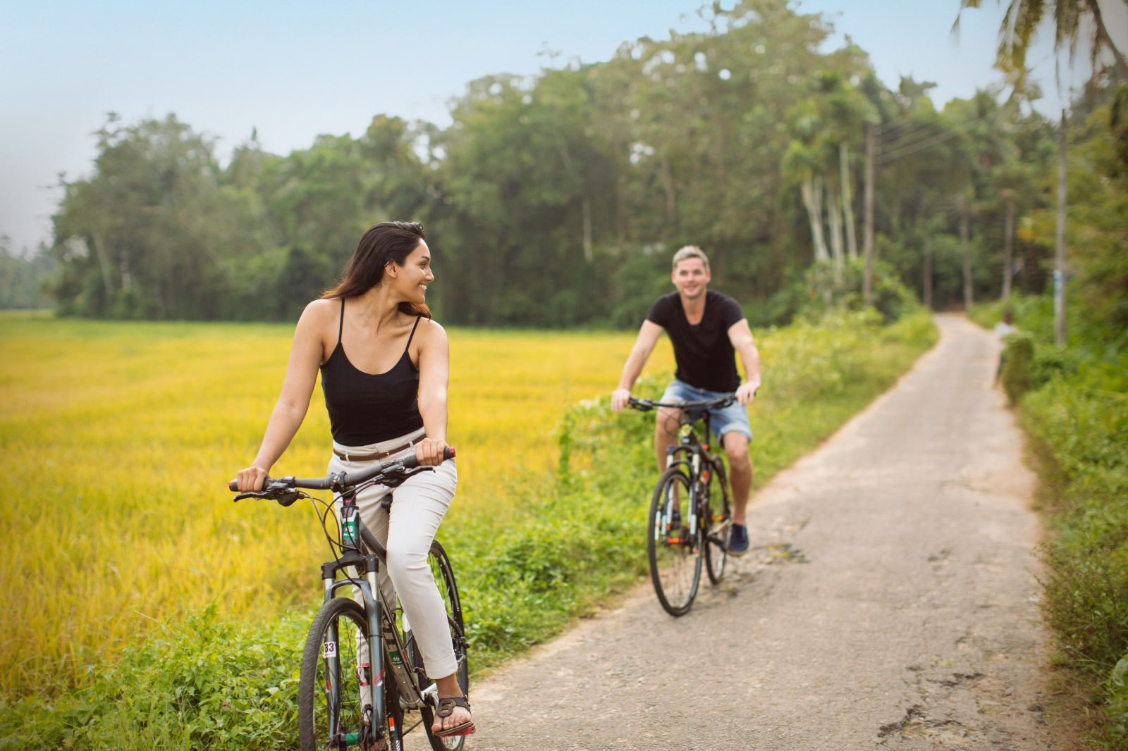 Couple biking along Sri Lanka's coast