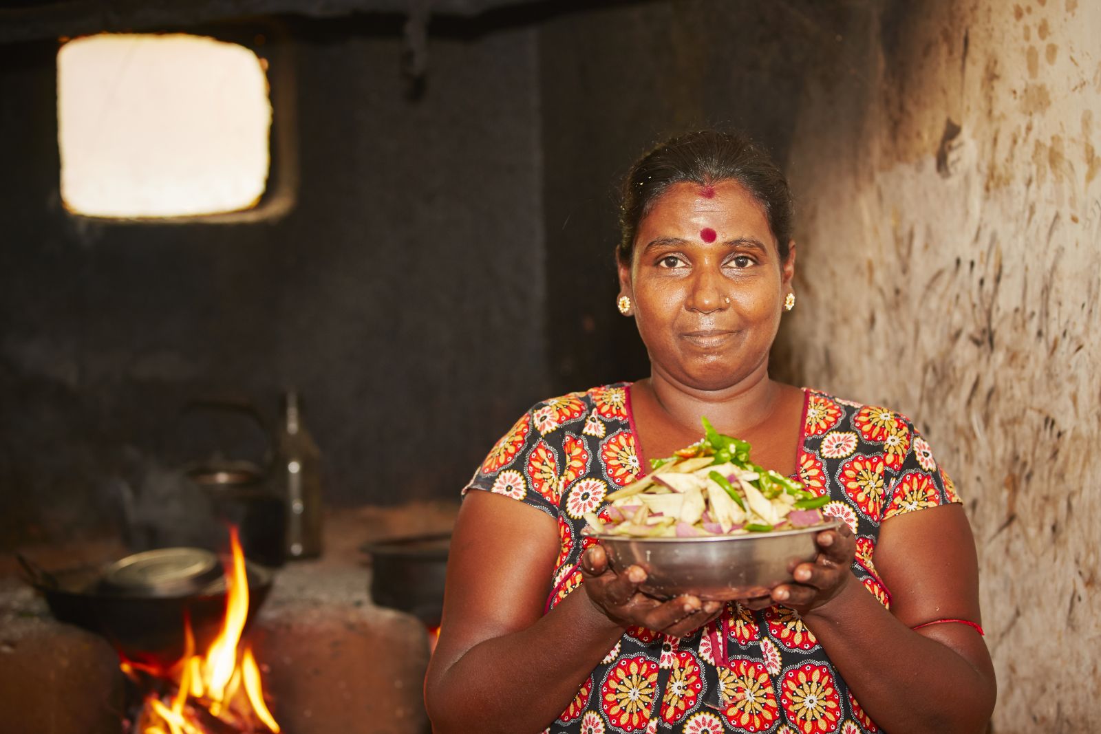 Lady serving food in her home in rural Sri Lanka