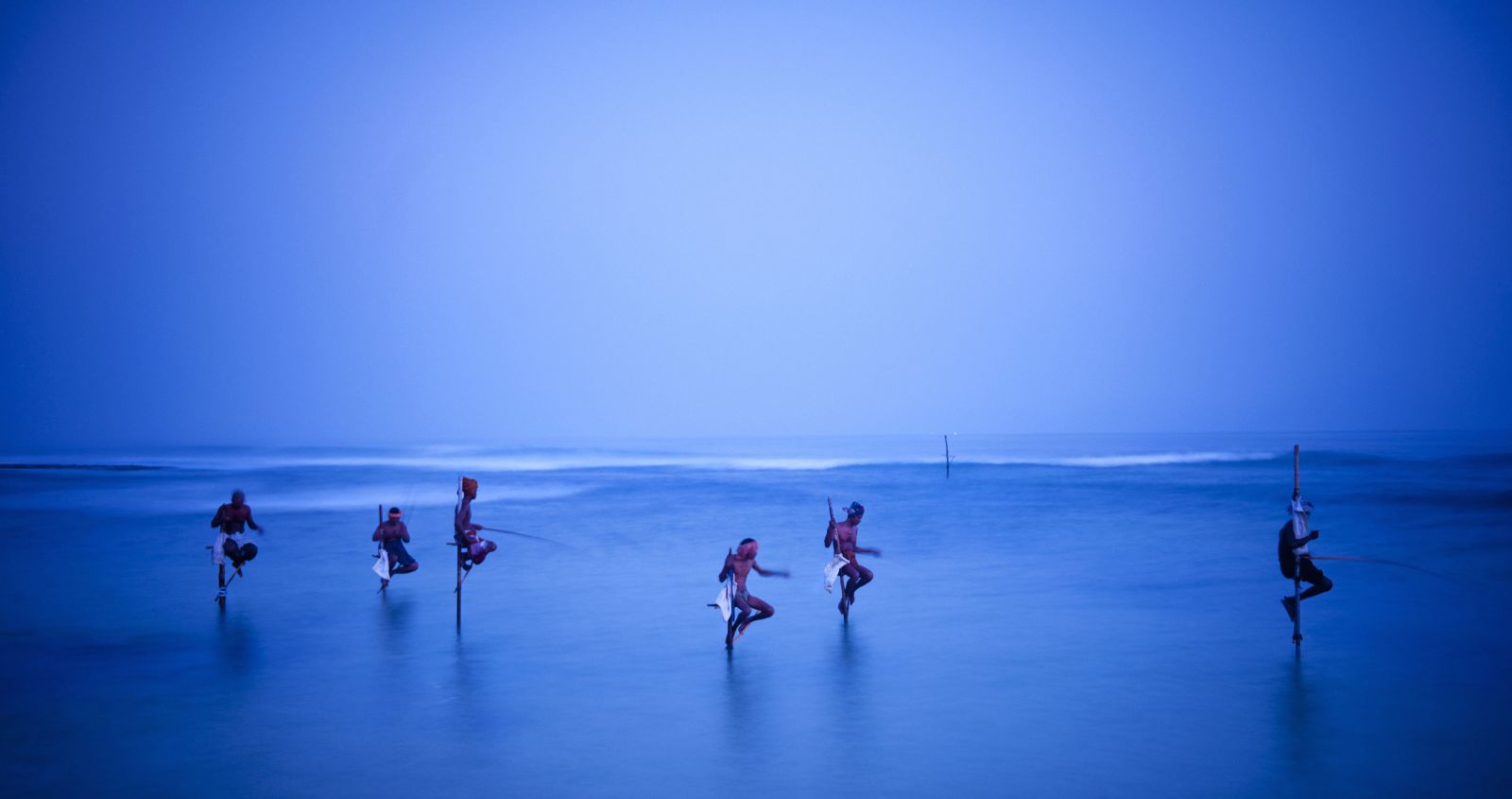 Traditional Sri Lankan stilt fisherman on the beach at sunrise