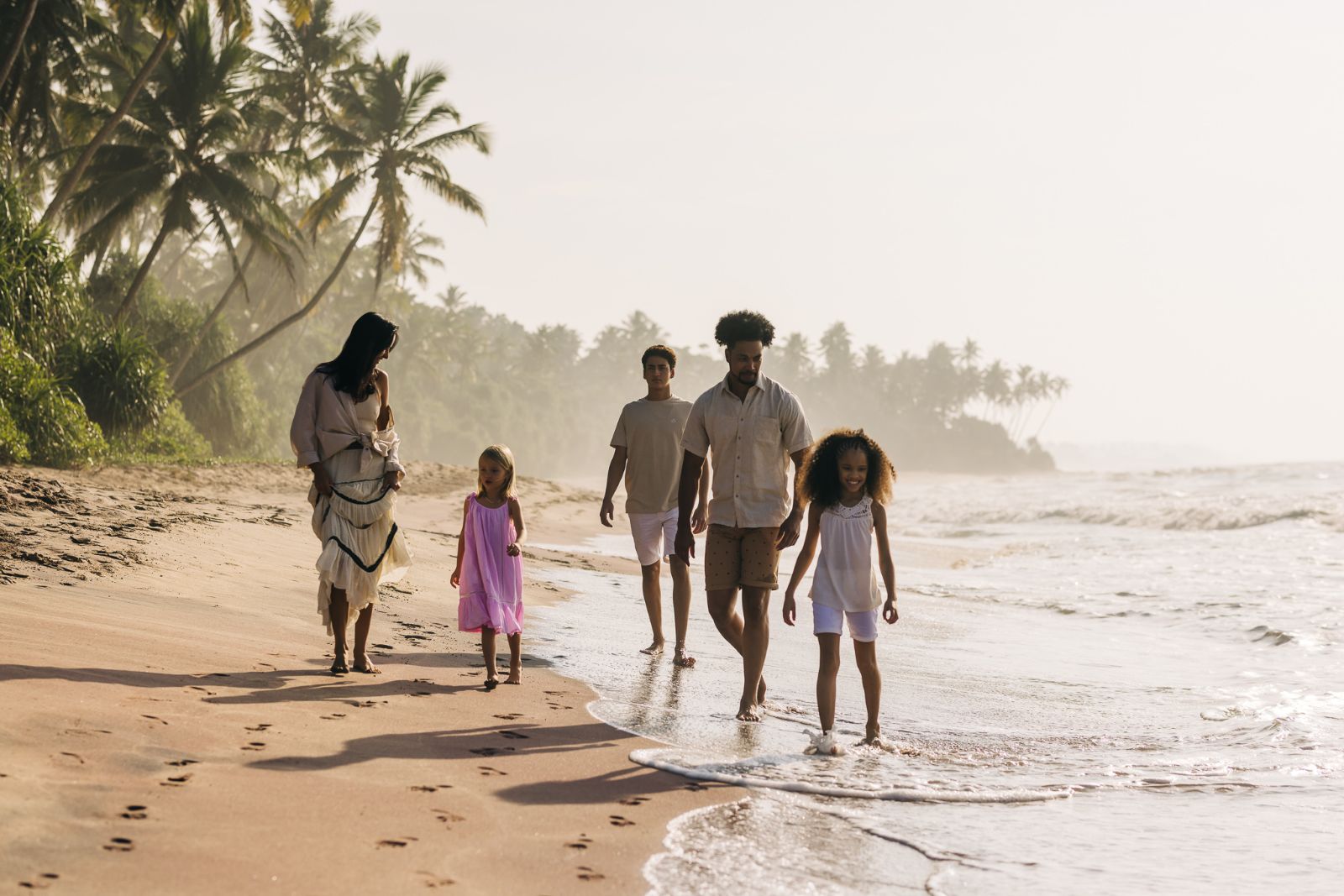 A family walking along the beachfront at ANI Sri Lanka on Sri Lanka's south coast