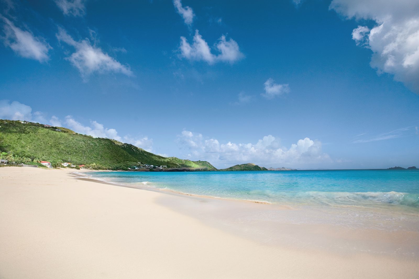 A view of the beach with white sands and blue sky at Hotel Cheval Blanc in St Barths