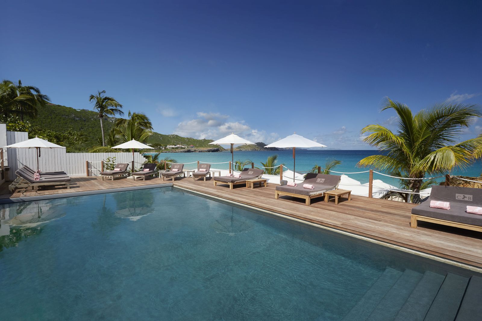 The pool at Hotel Cheval Blanc in St Barths with the sea on the background